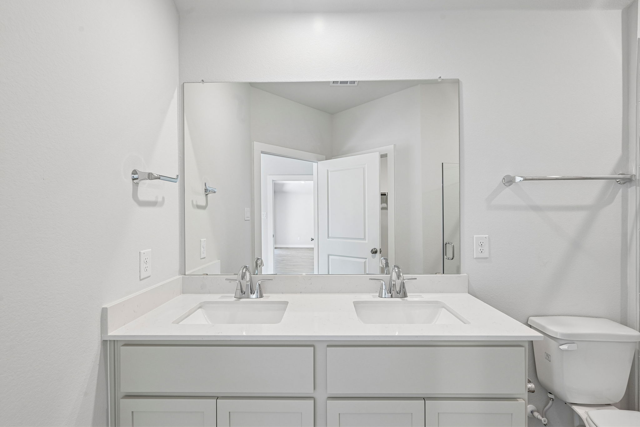 A bathroom with a large mirror.