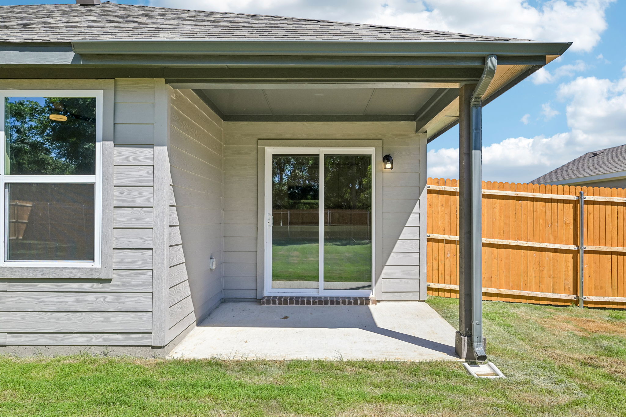 A house with a fence and a porch.