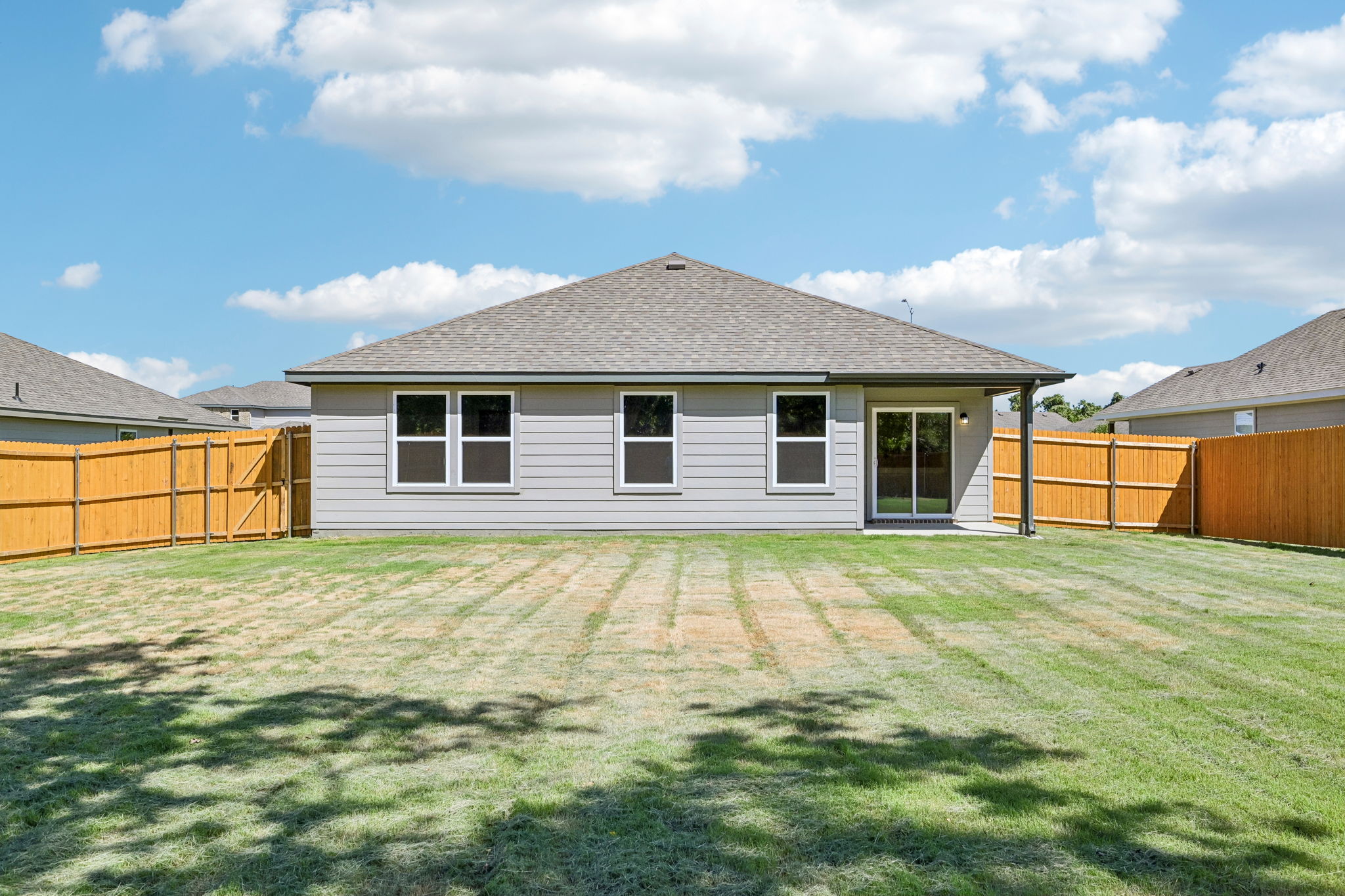 A house with a grass yard.