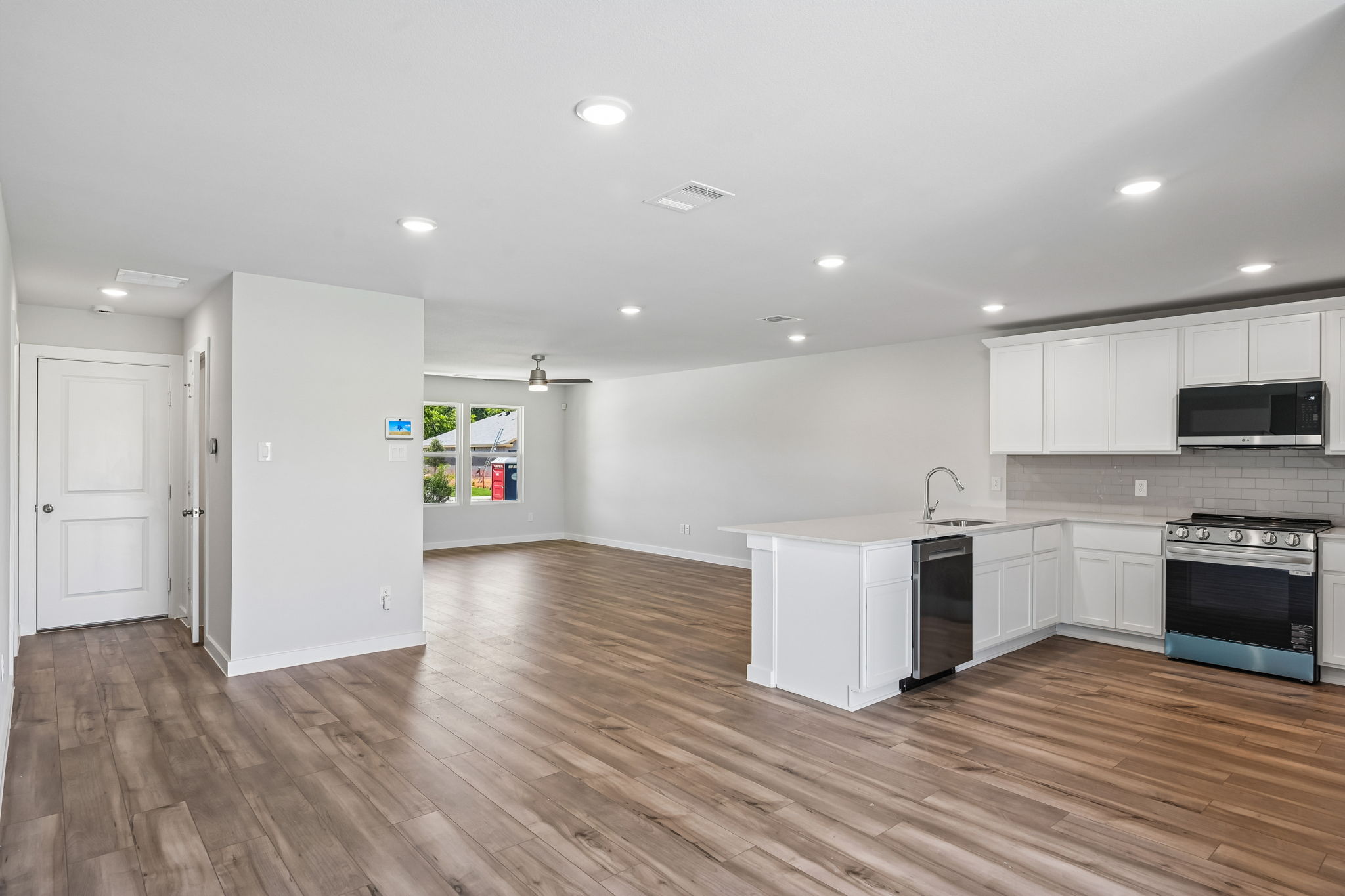 A kitchen with white cabinets.