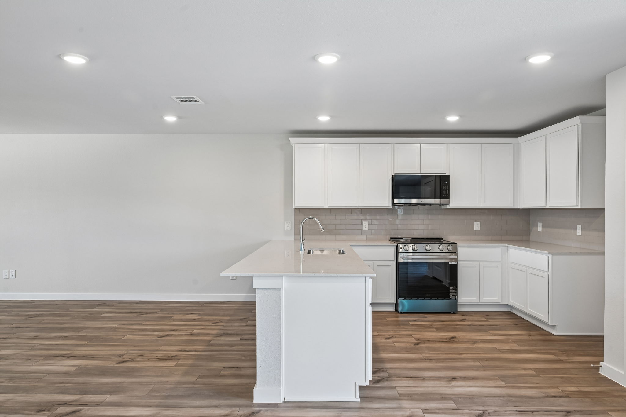 A kitchen with white cabinets.