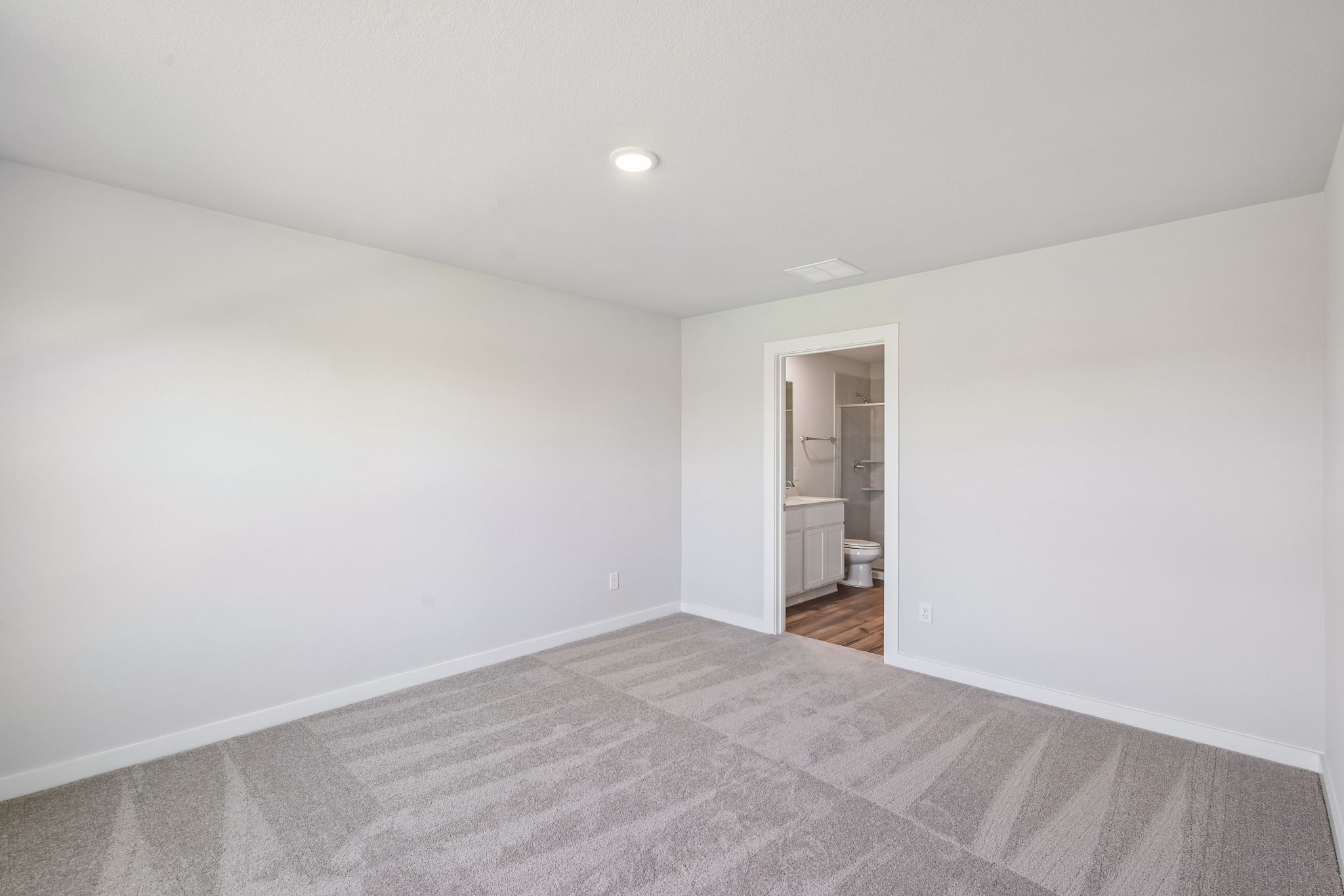 A room with a bed and a door.