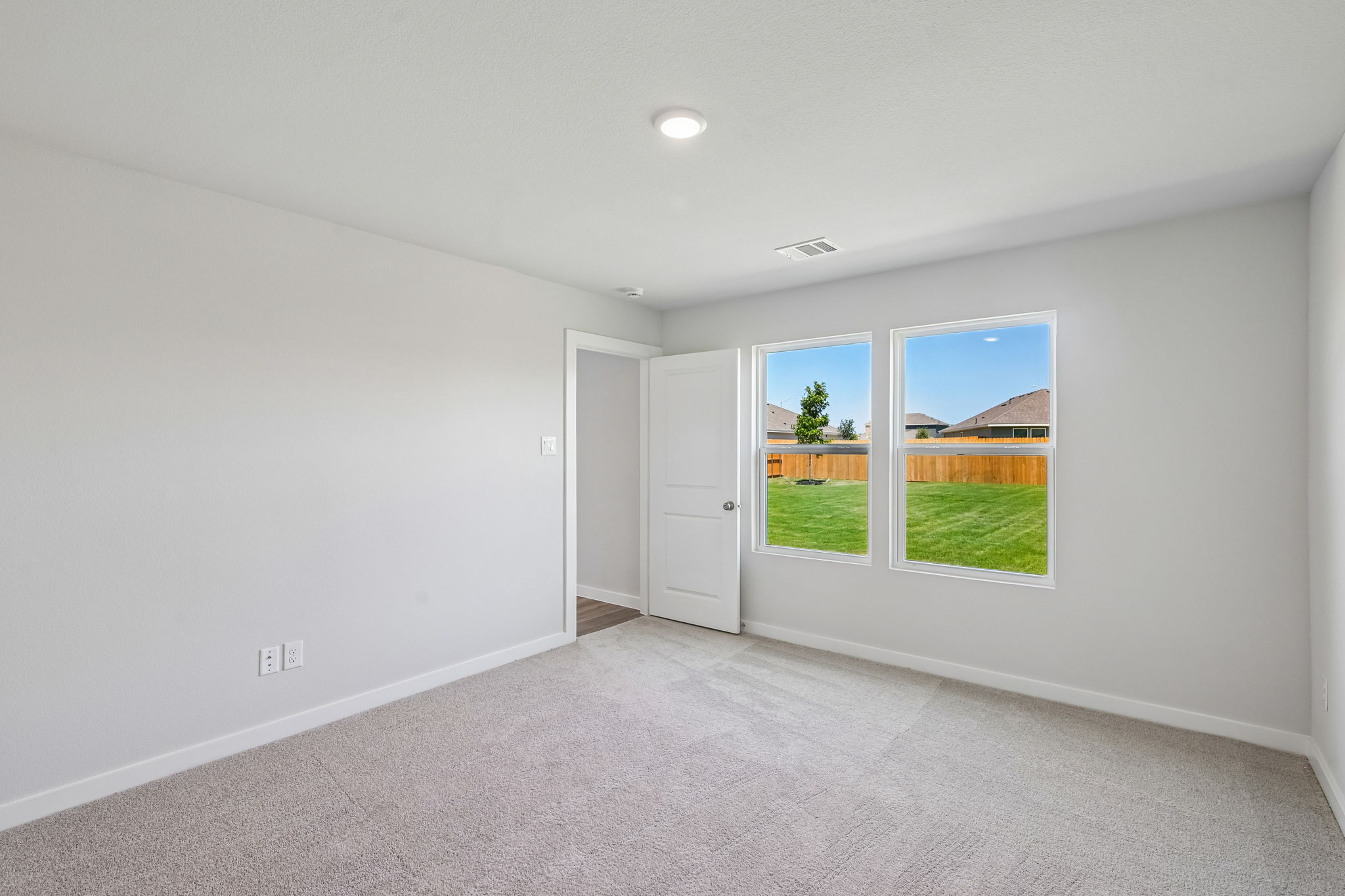 A room with a window and a door.
