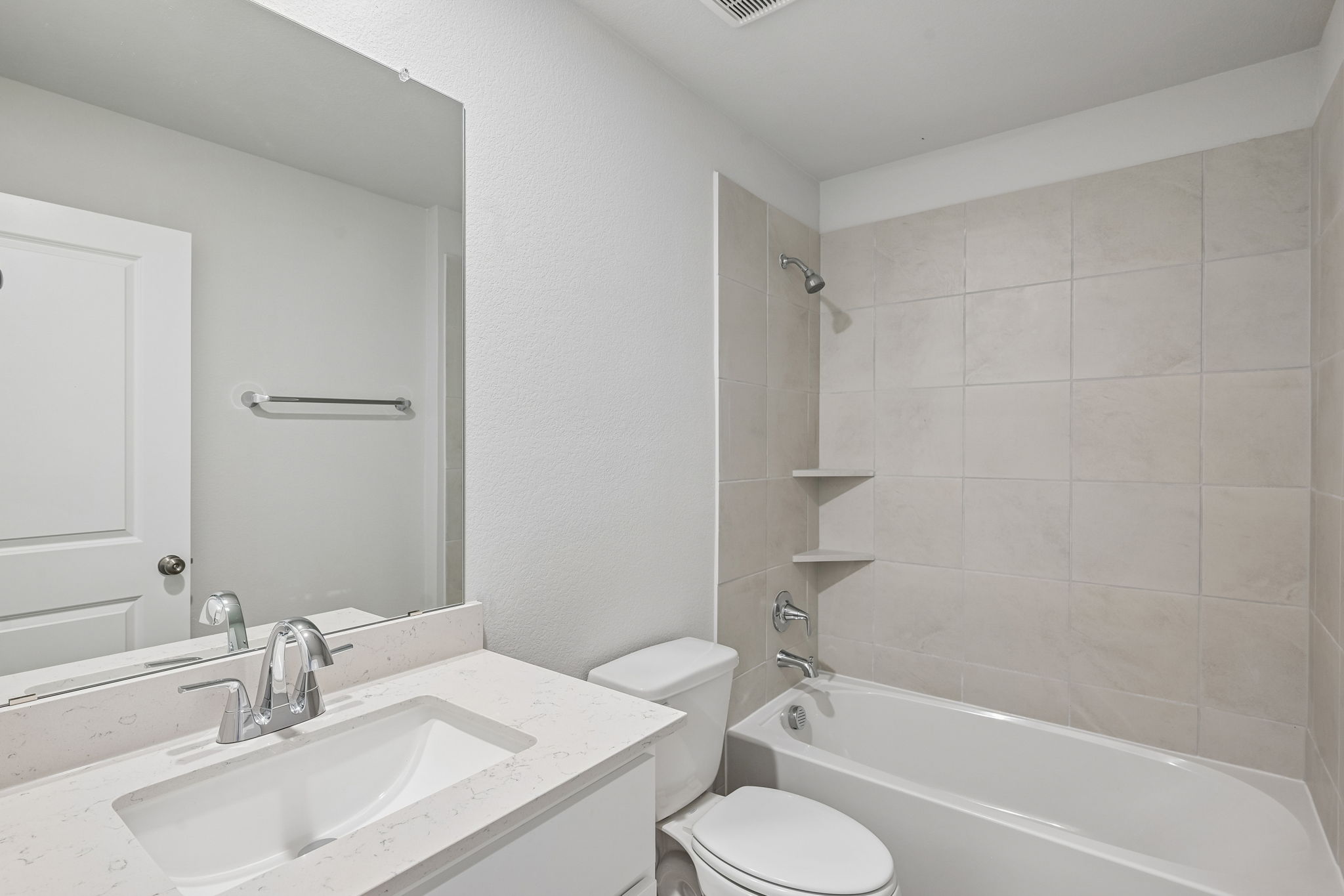 A bathroom with a tub sink and toilet.