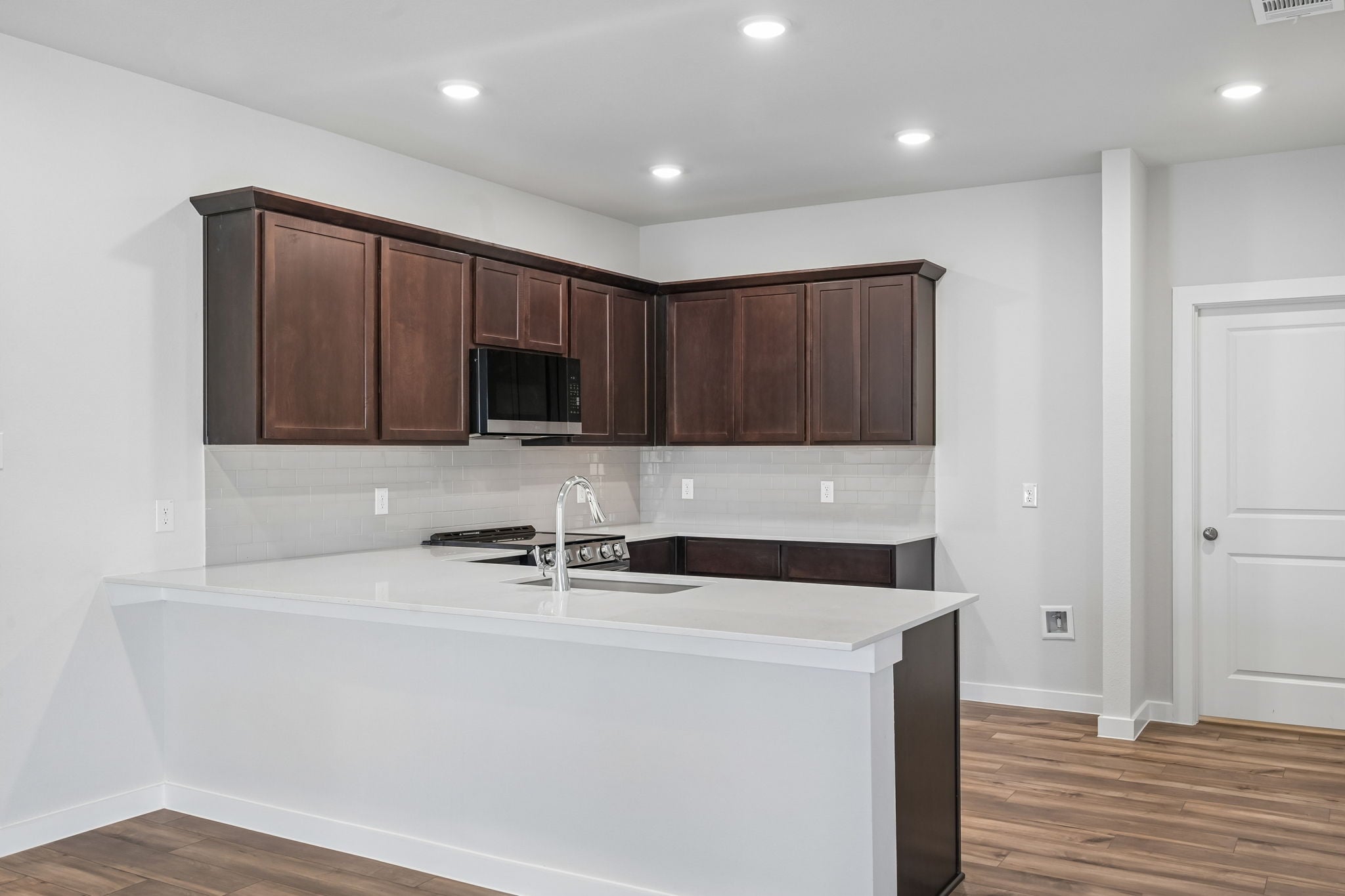 A kitchen with wooden cabinets.