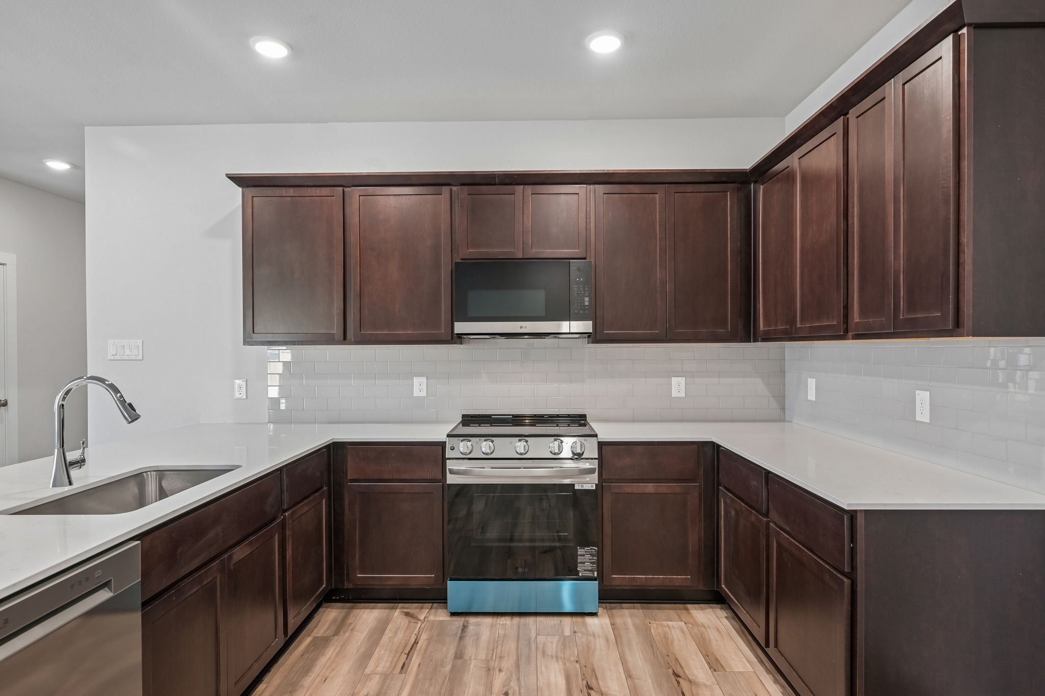 A kitchen with wooden cabinets.