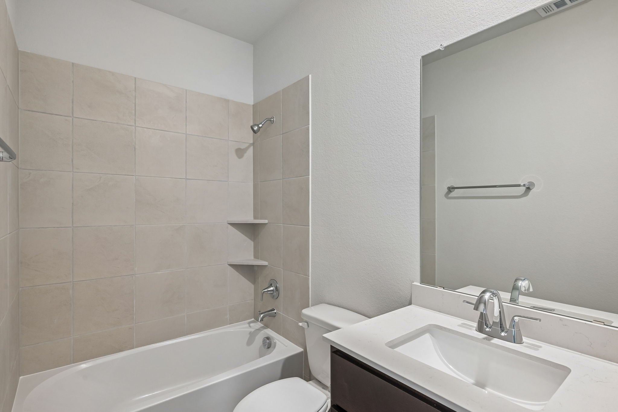 A bathroom with a tub sink and toilet.