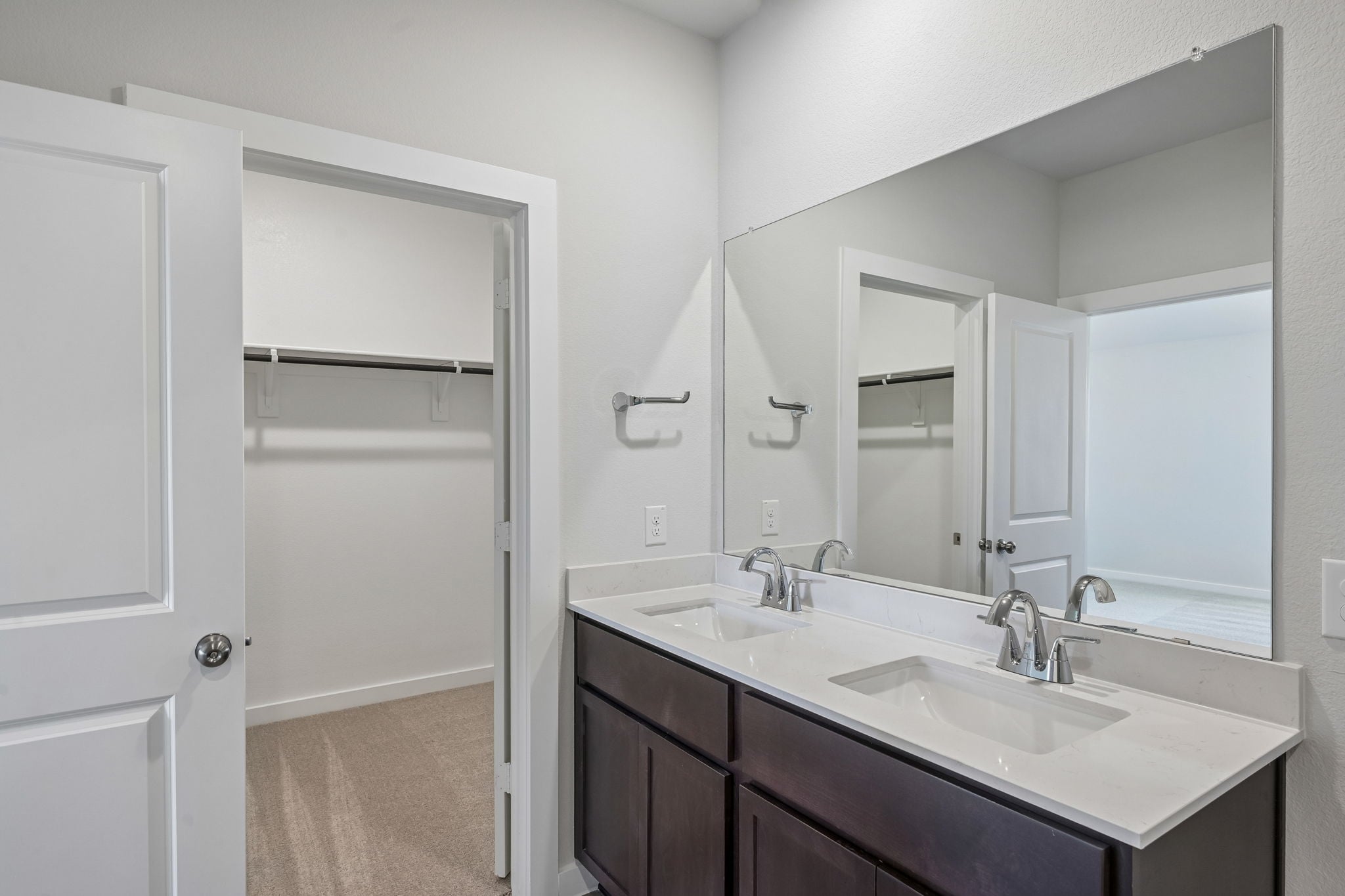 A bathroom with a sink and a shower unit.