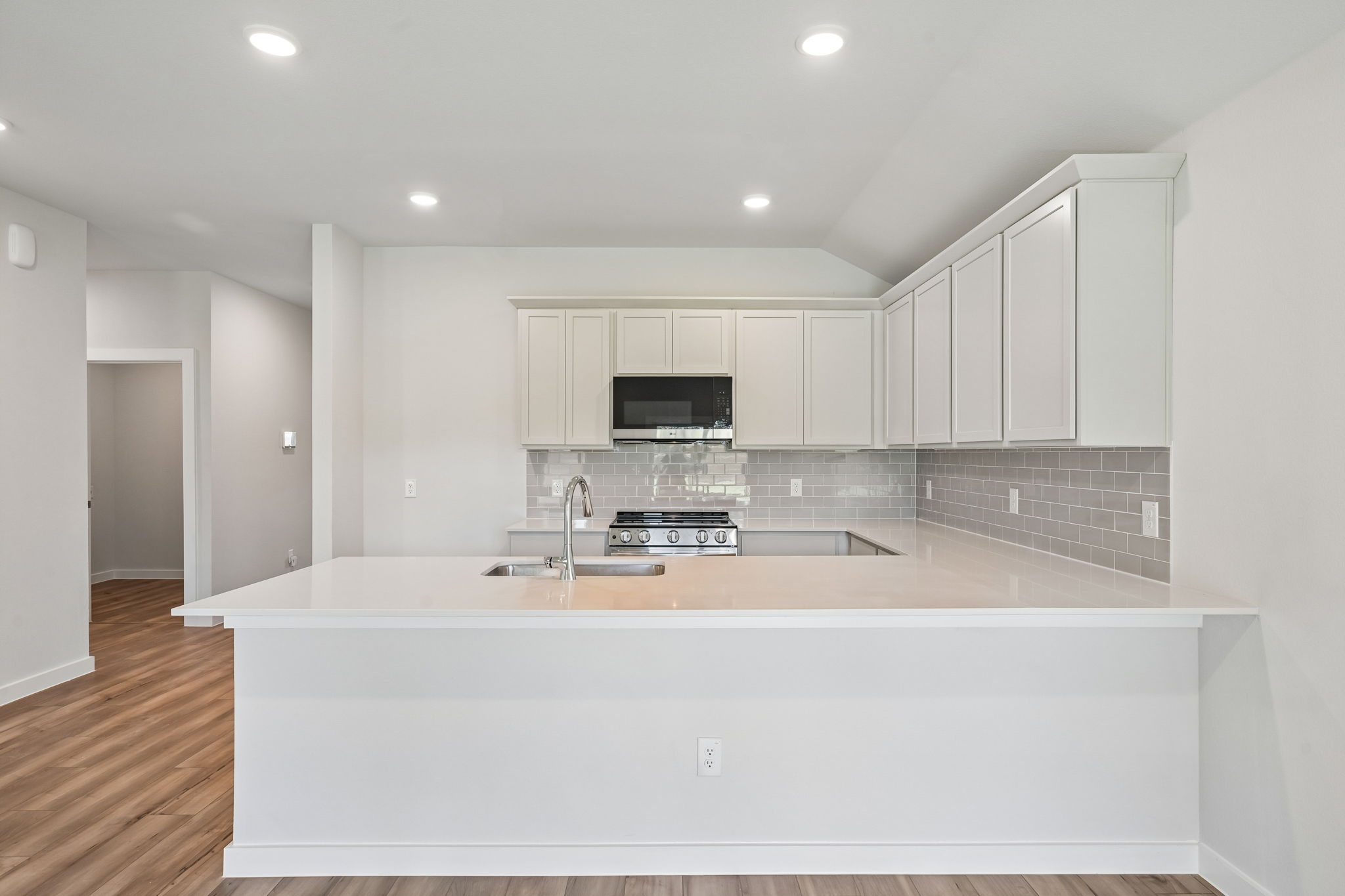 A kitchen with white cabinets.