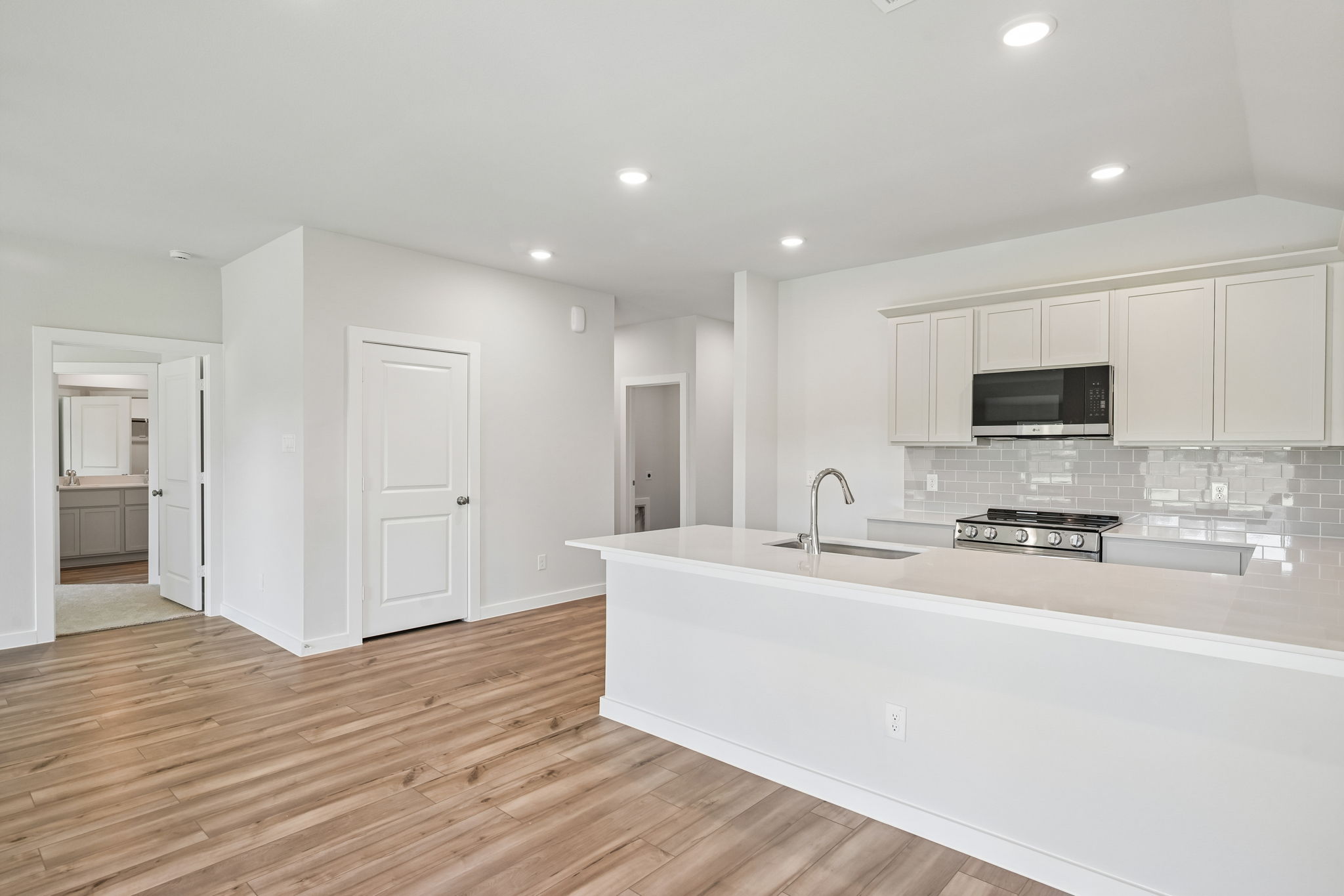 A kitchen with white cabinets.