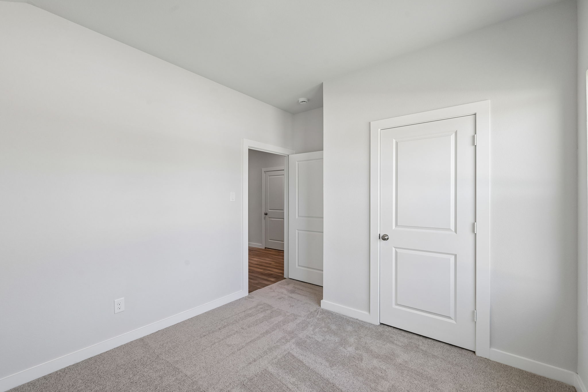 A hallway with white doors.