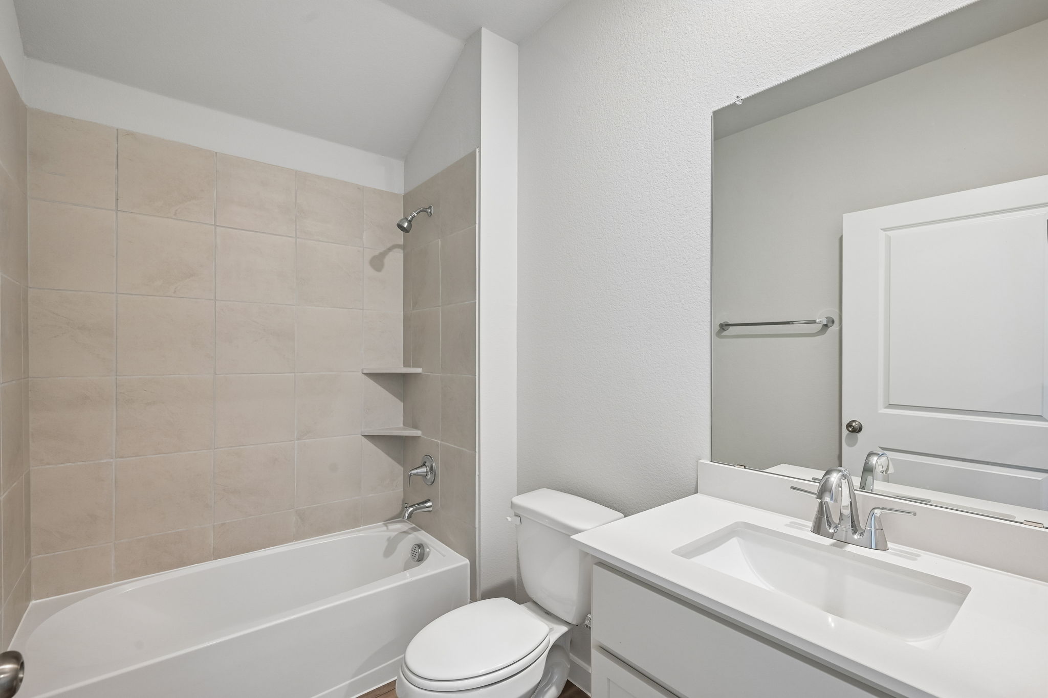 A bathroom with a tub sink and toilet.