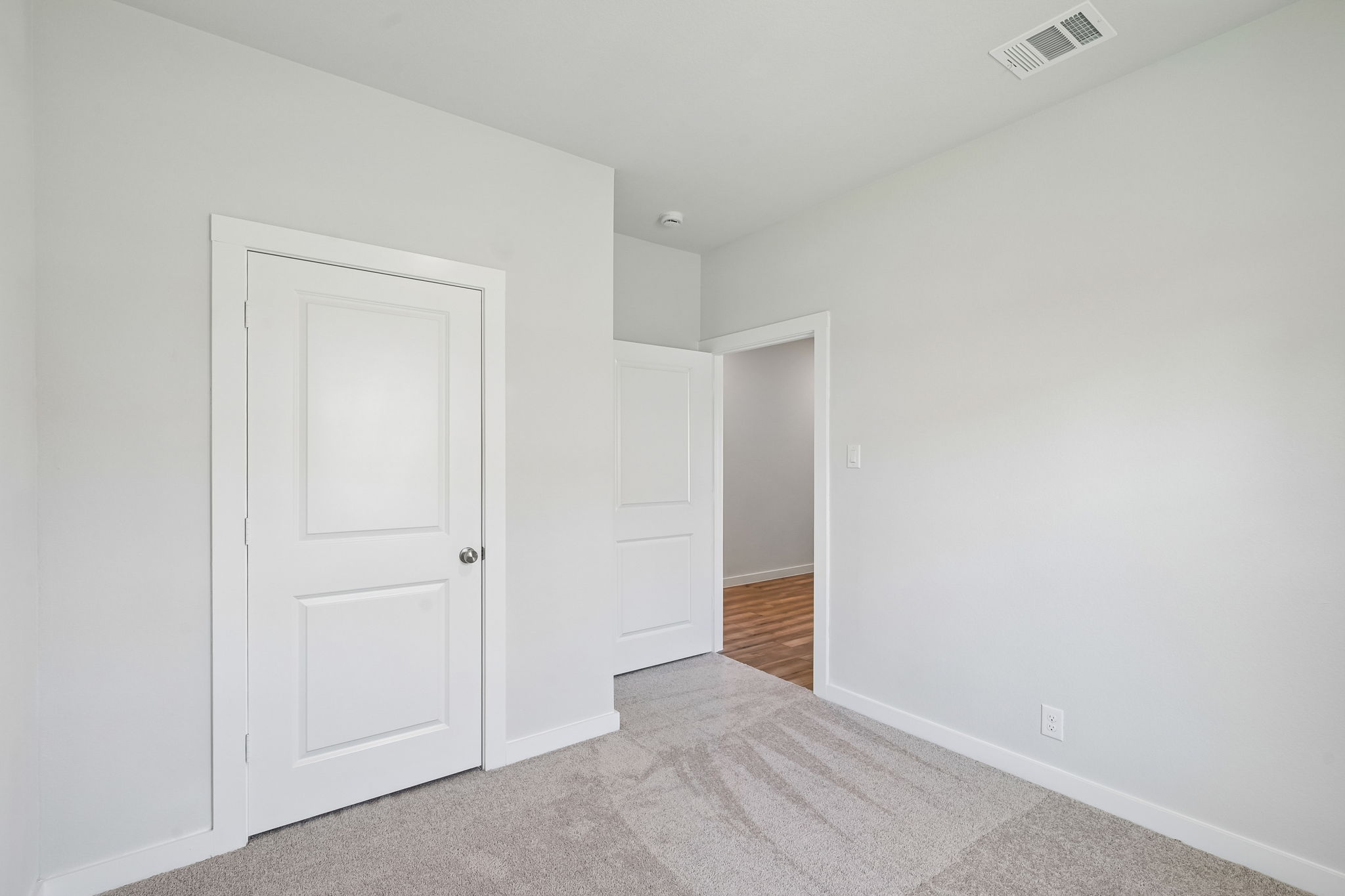 A hallway with white doors.
