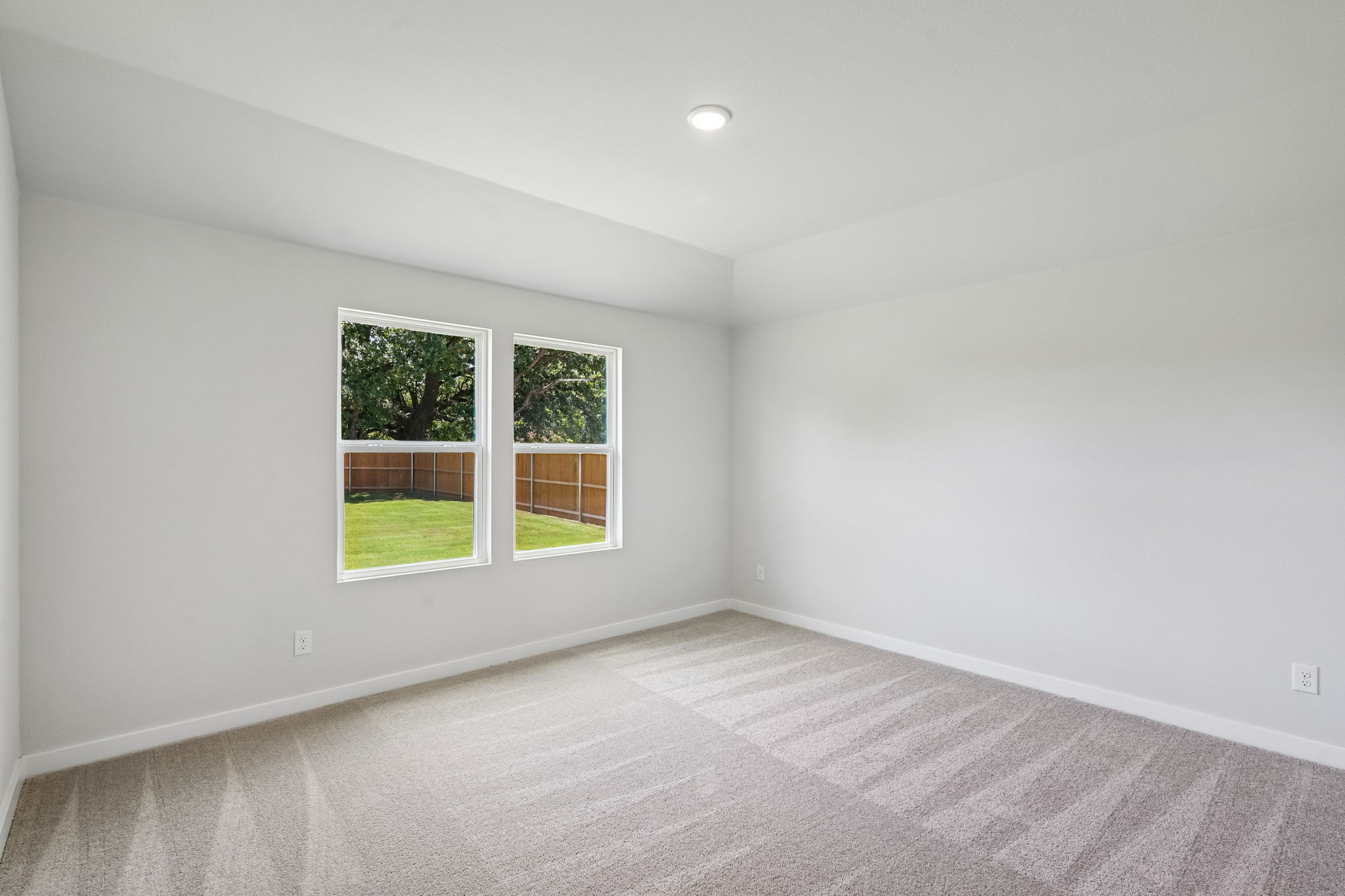 A room with a window and a carpet.