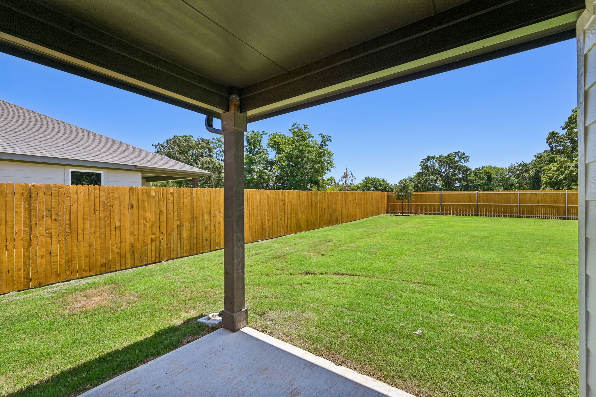 A backyard with a fence and a wood fence.