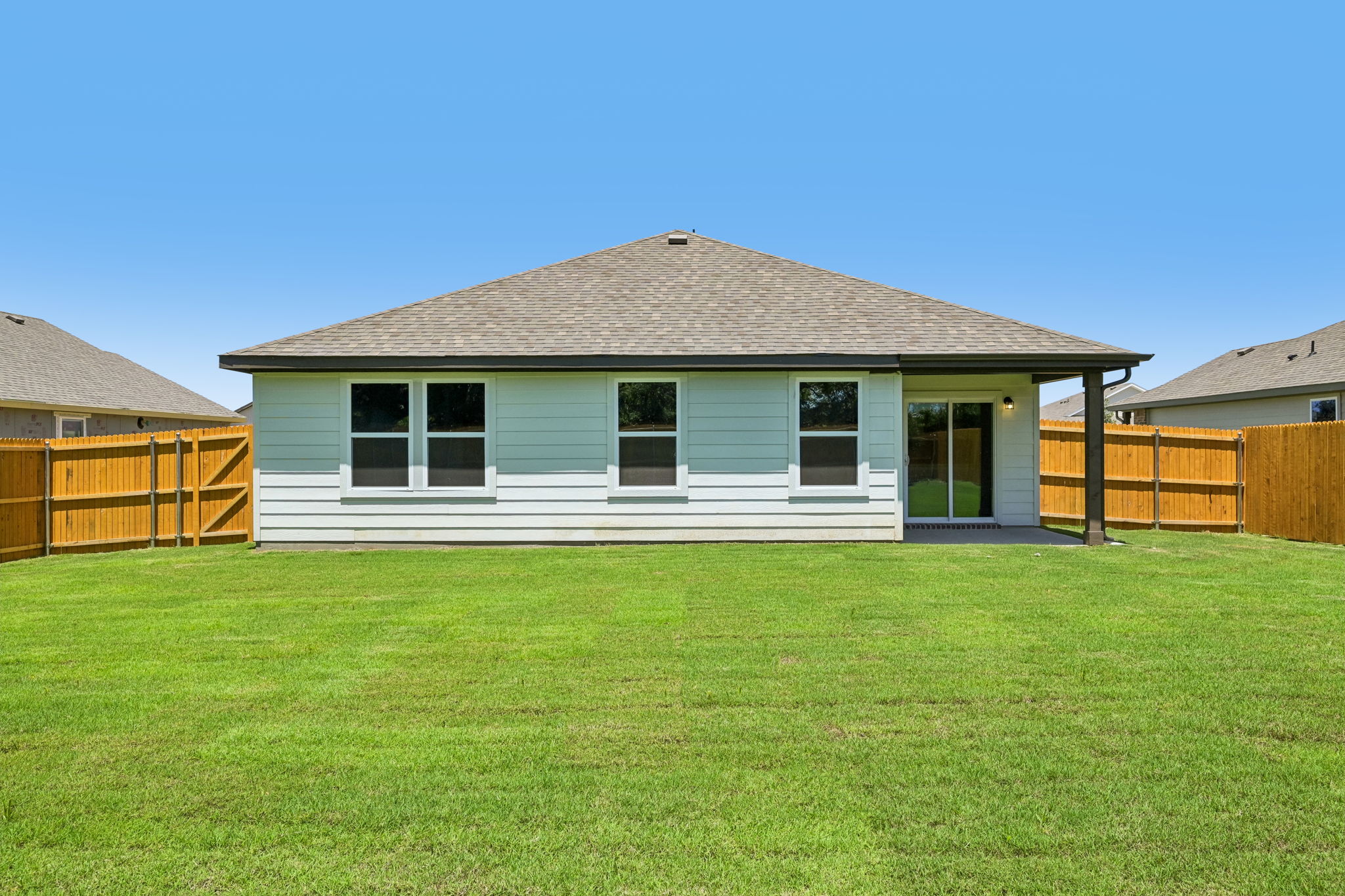 A house with a grass yard.