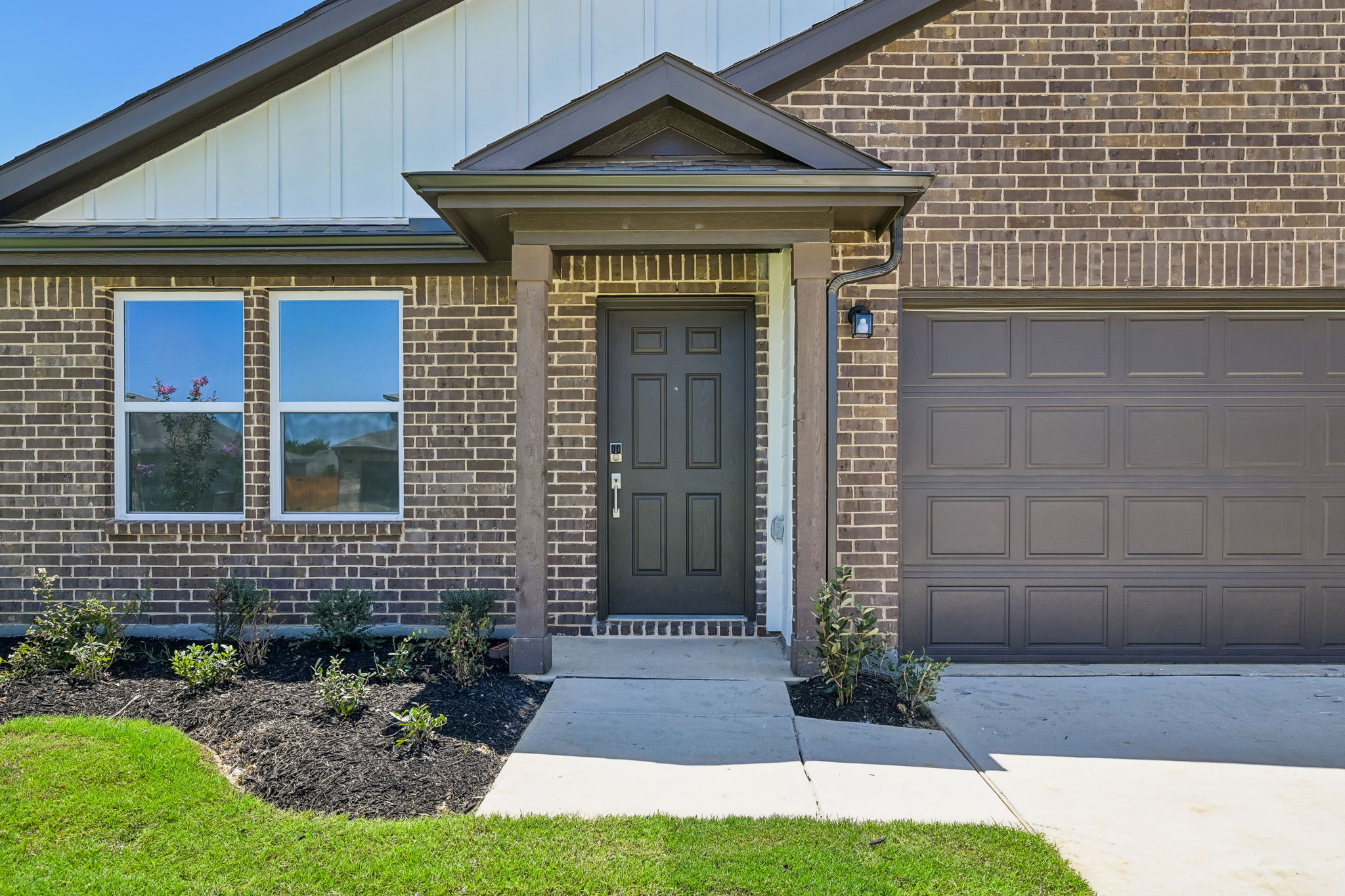 A house with a garage and a door.