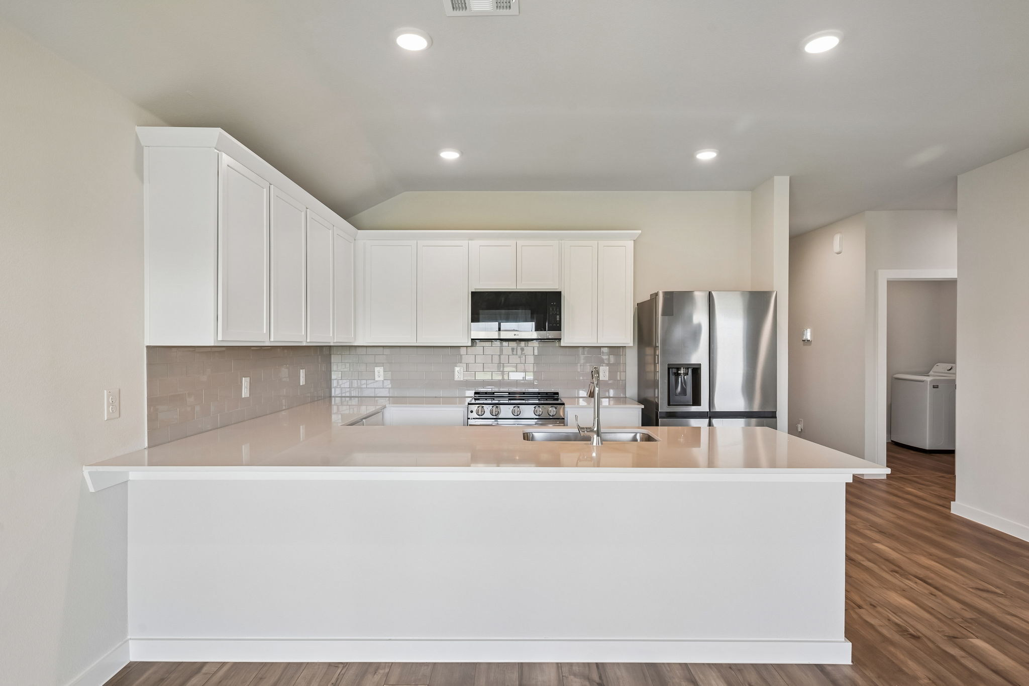 A kitchen with white cabinets.