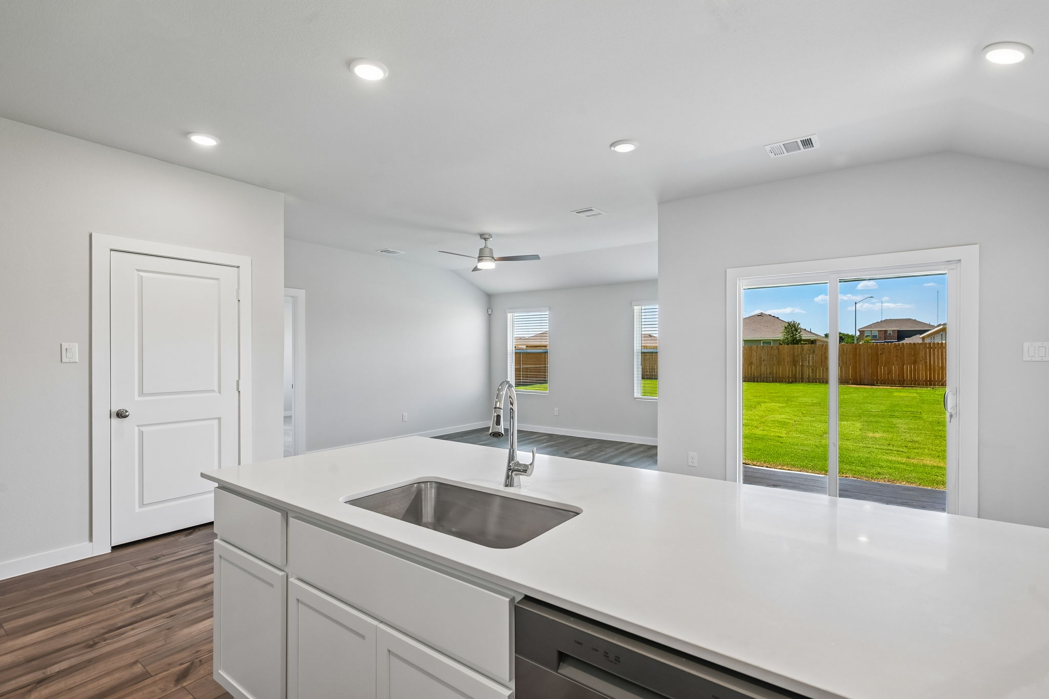 A kitchen with a large window.