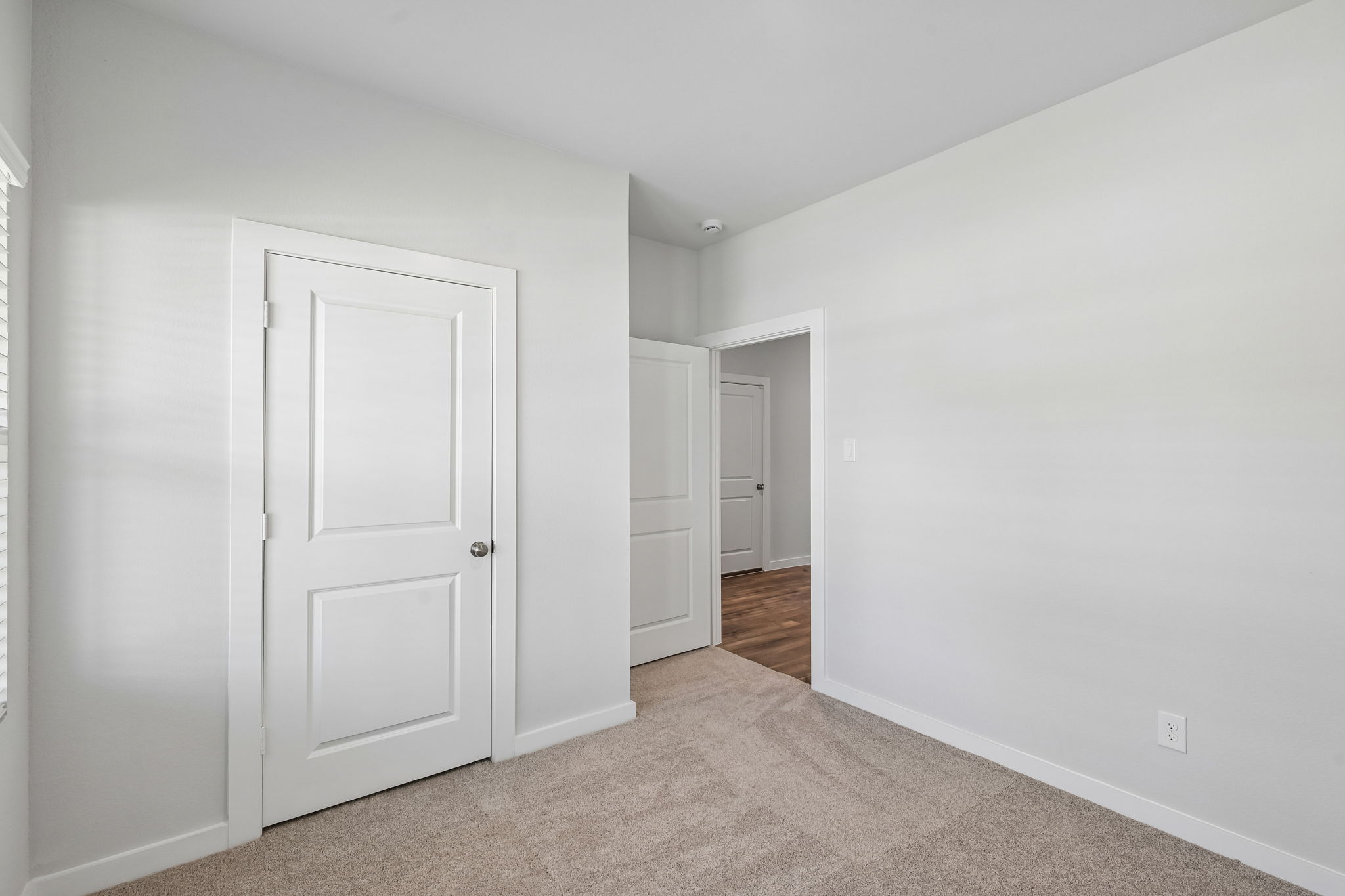 A hallway with white doors.