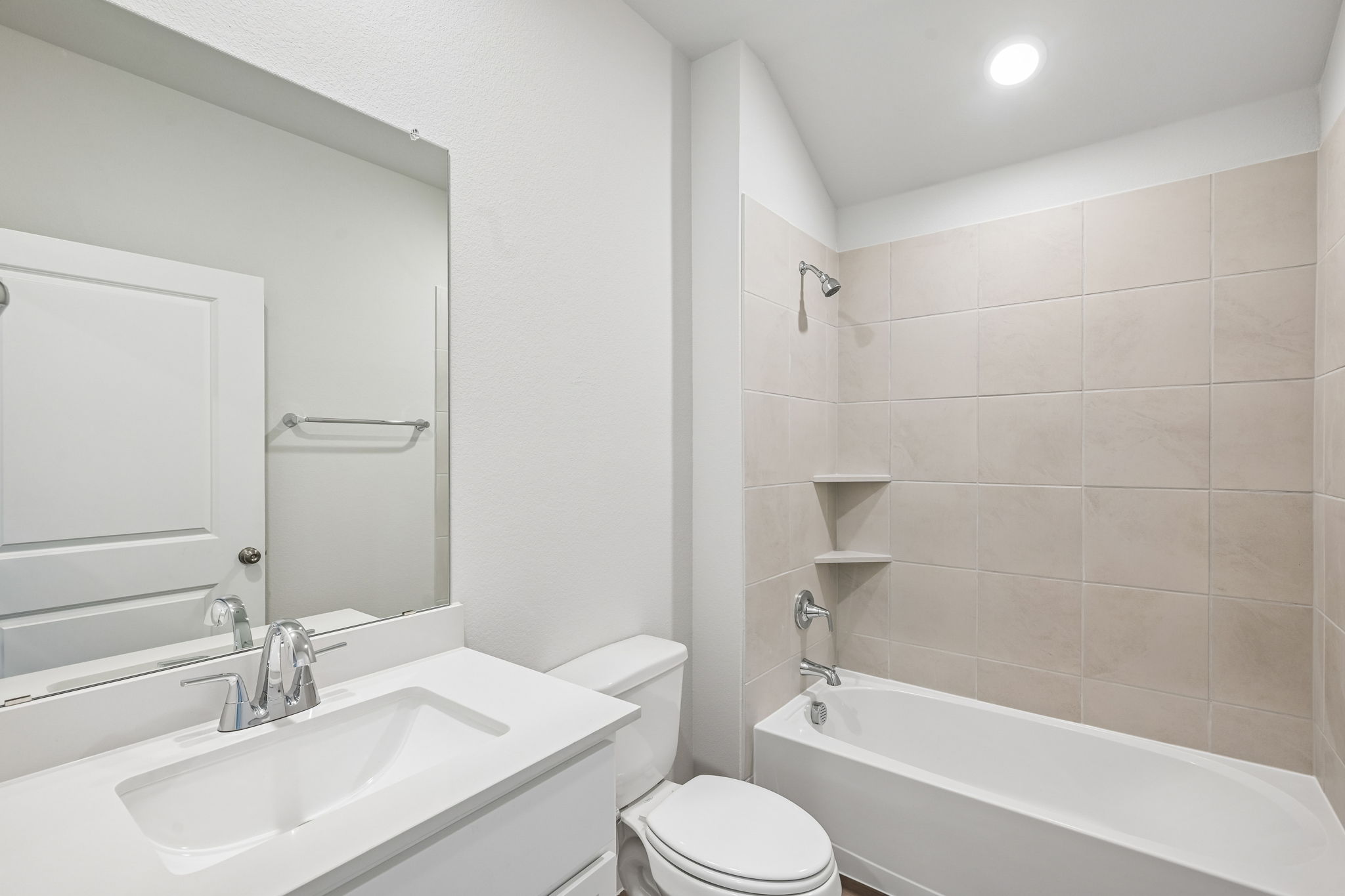 A bathroom with a tub sink and toilet.