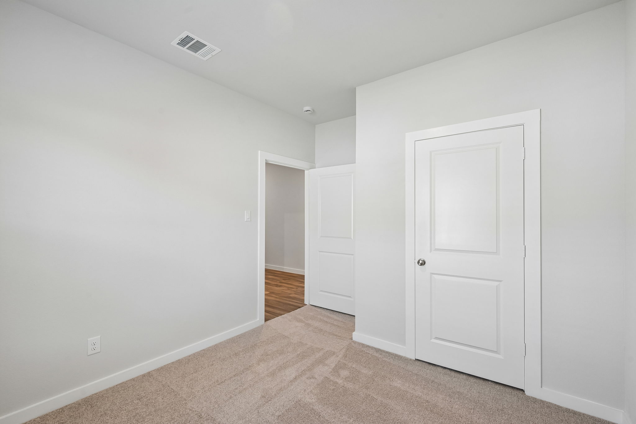 A hallway with white doors.