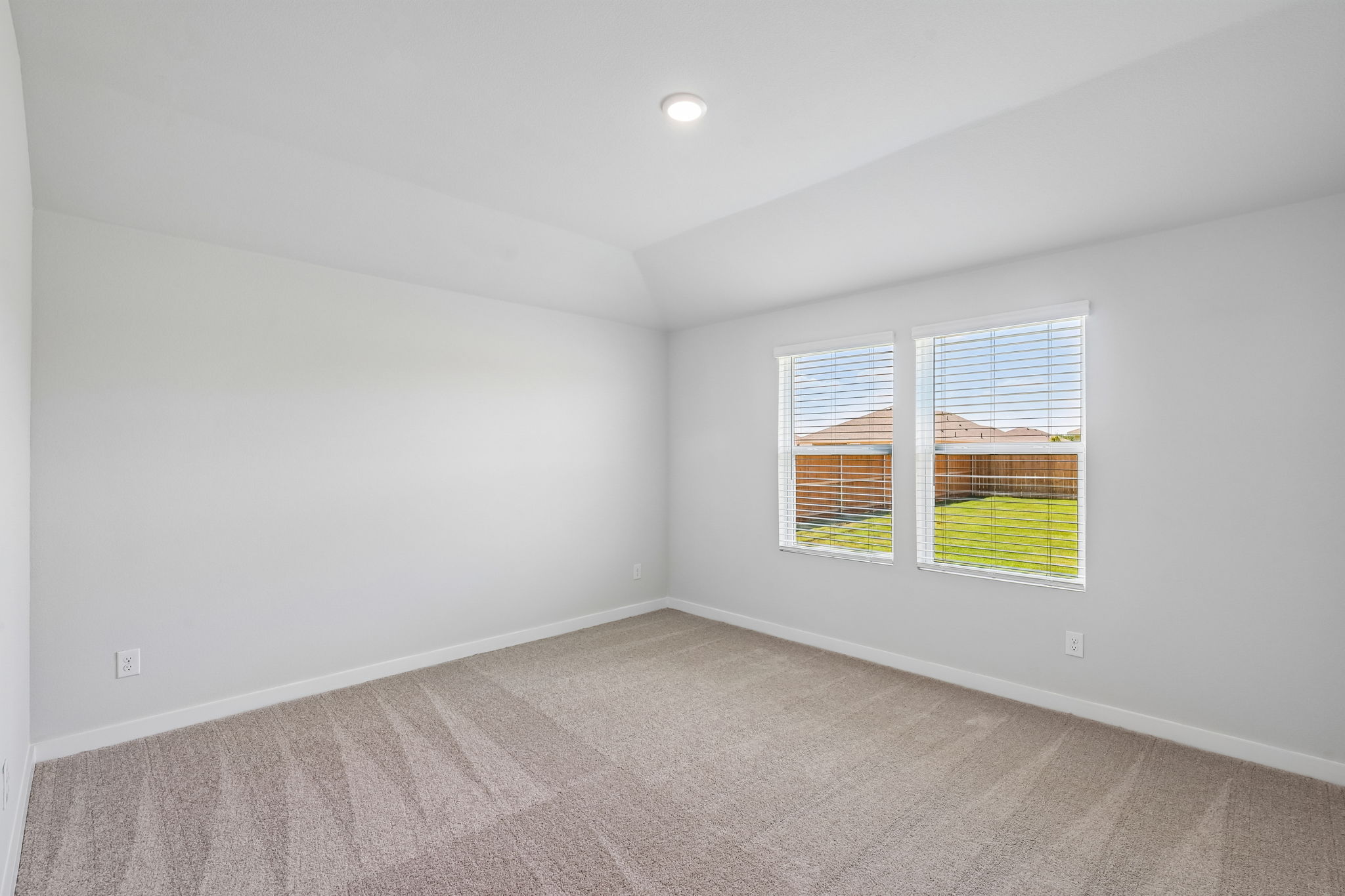 A room with a window and a carpet.