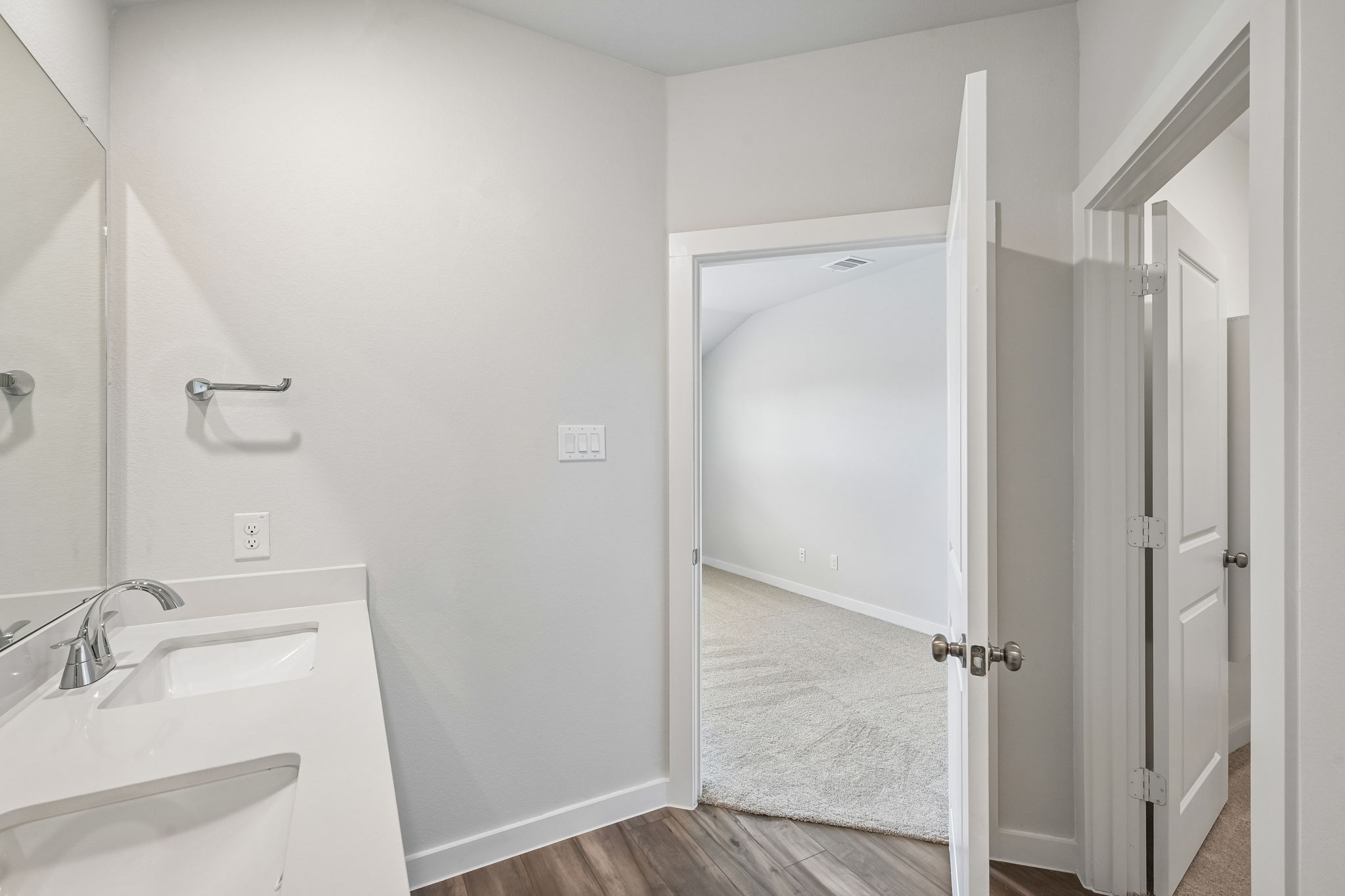 A bathroom with a shower and sink.