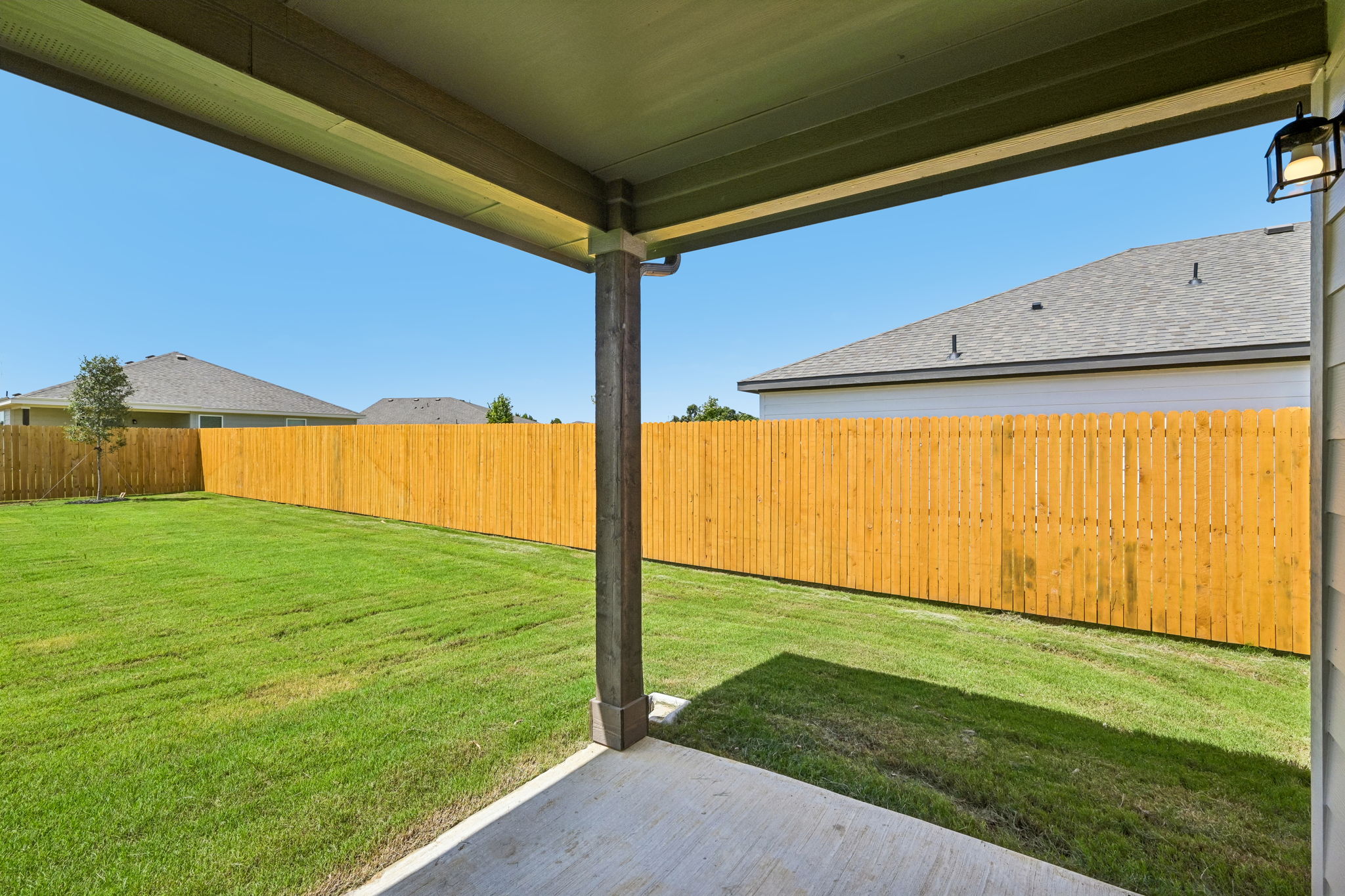 A backyard with a fence.