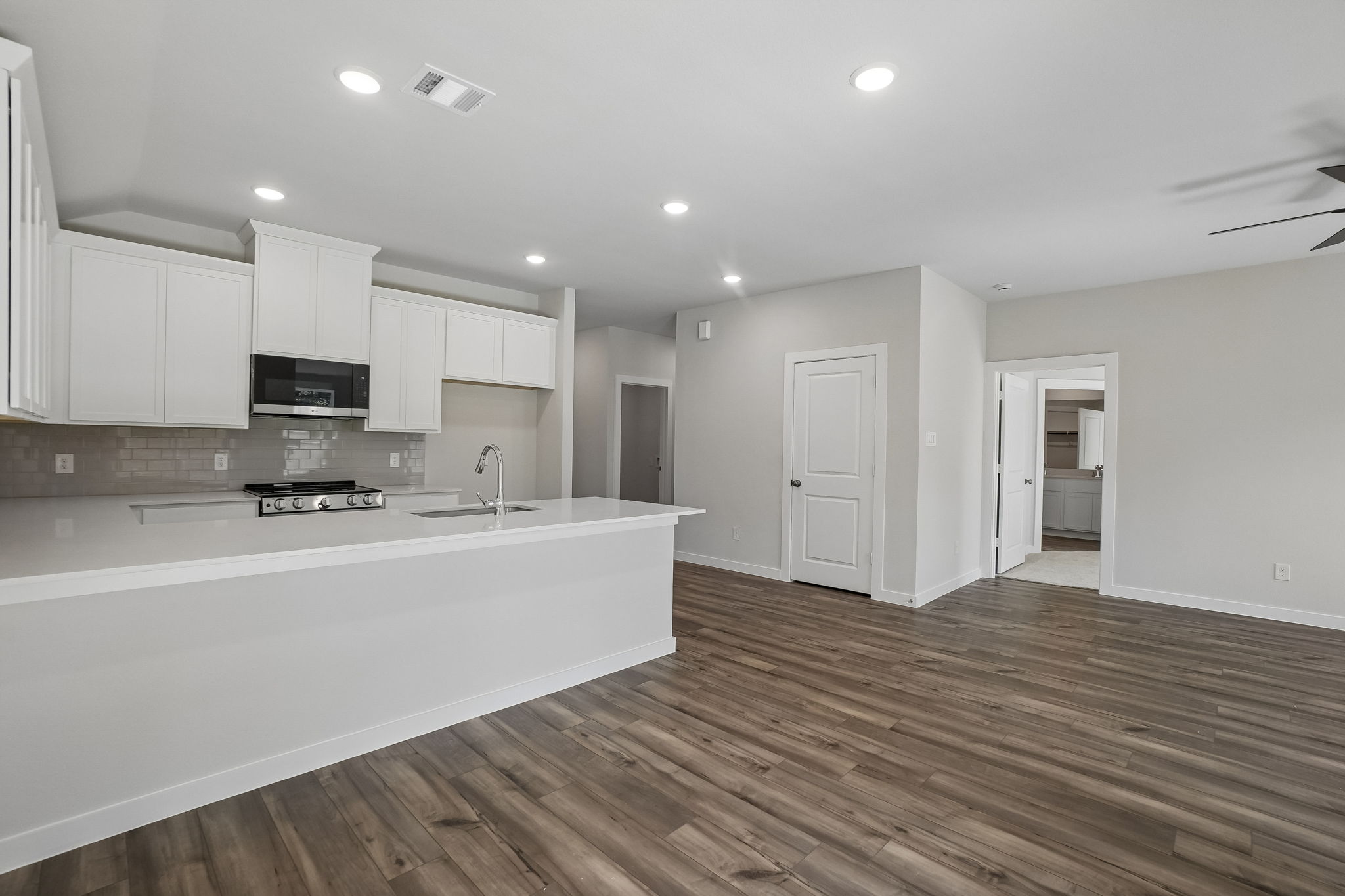 A kitchen with white cabinets.