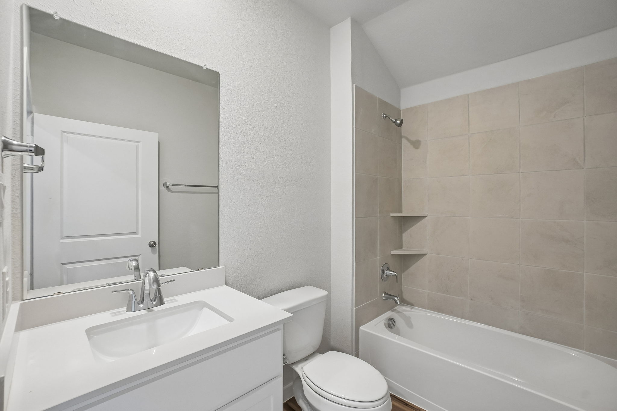 A bathroom with a tub sink and toilet.