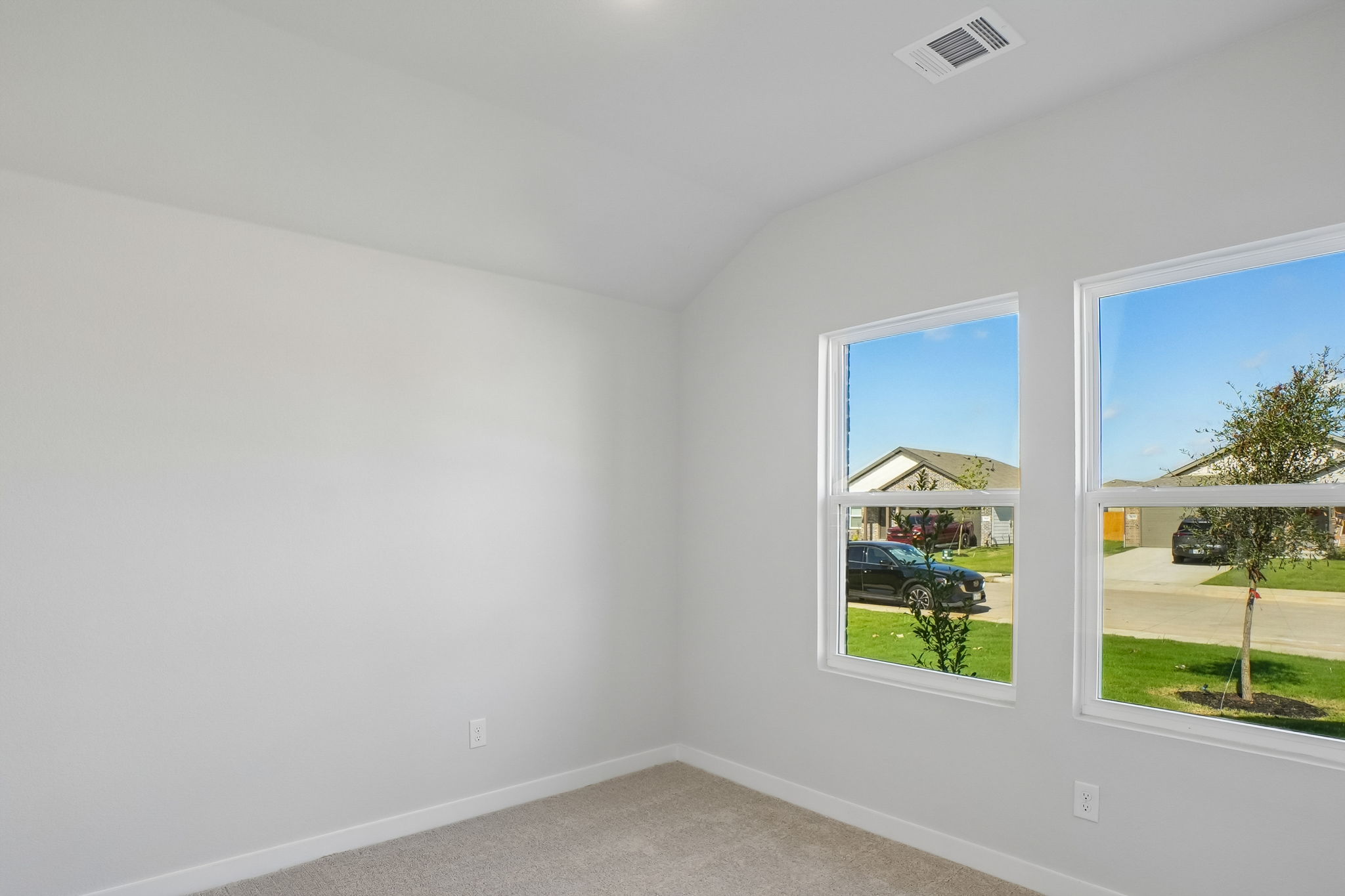 A room with a window and a car outside.