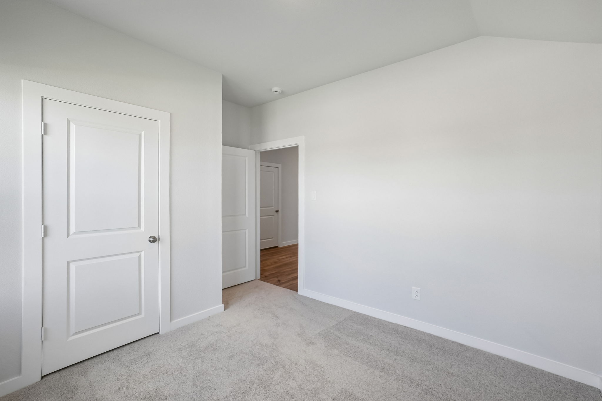 A hallway with white walls.