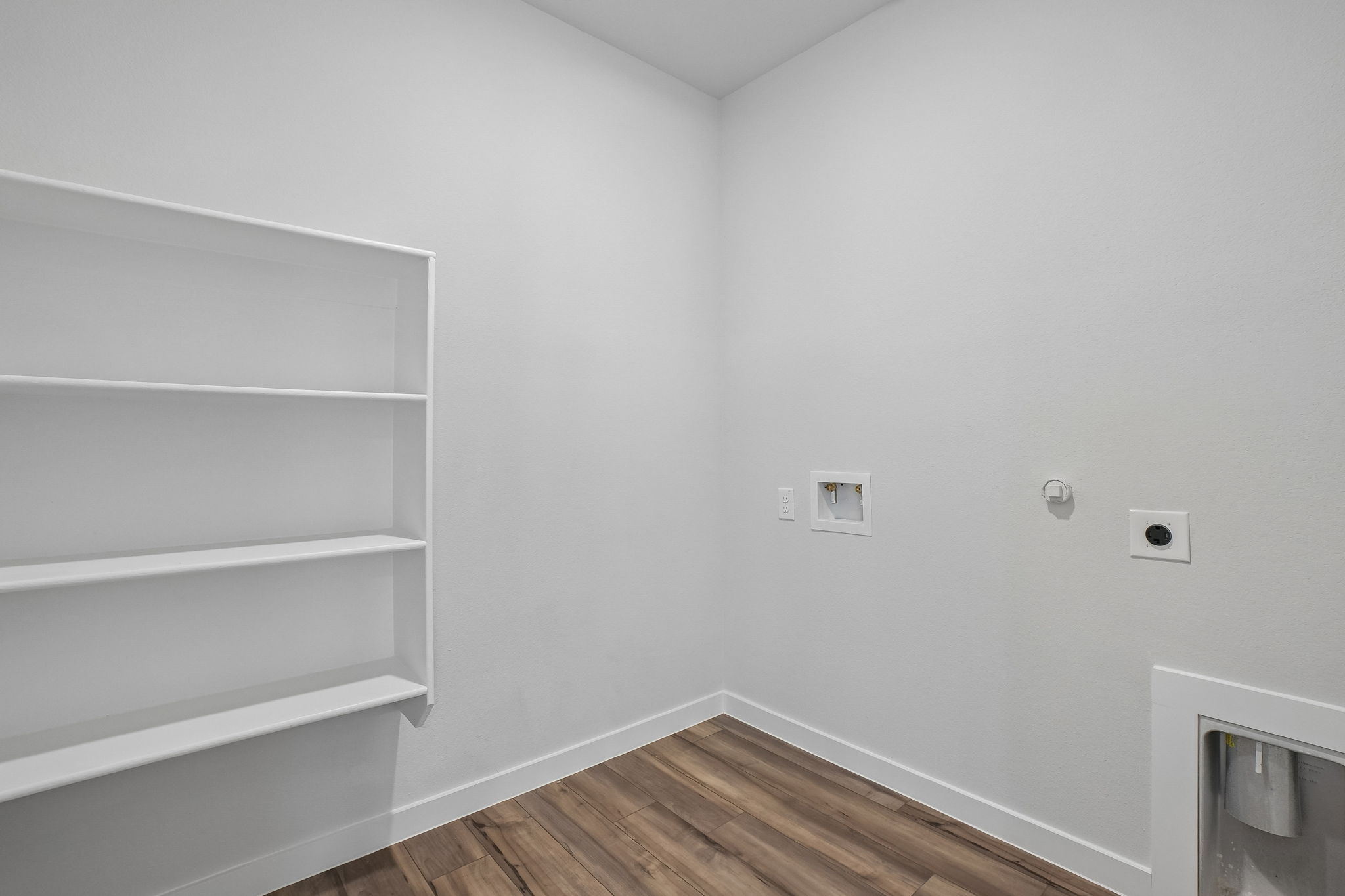 A white room with a wood floor.