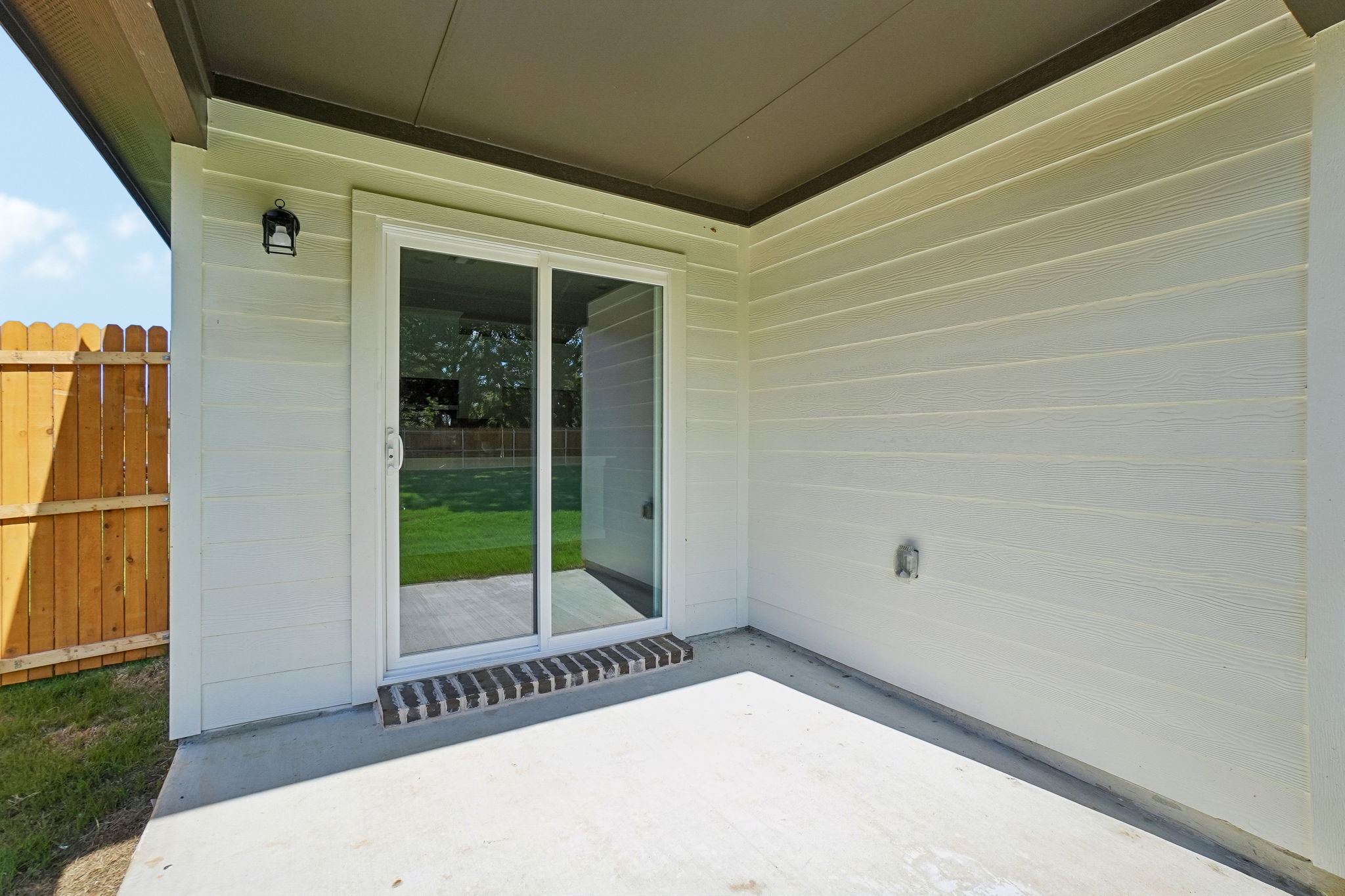 A white building with a glass door.