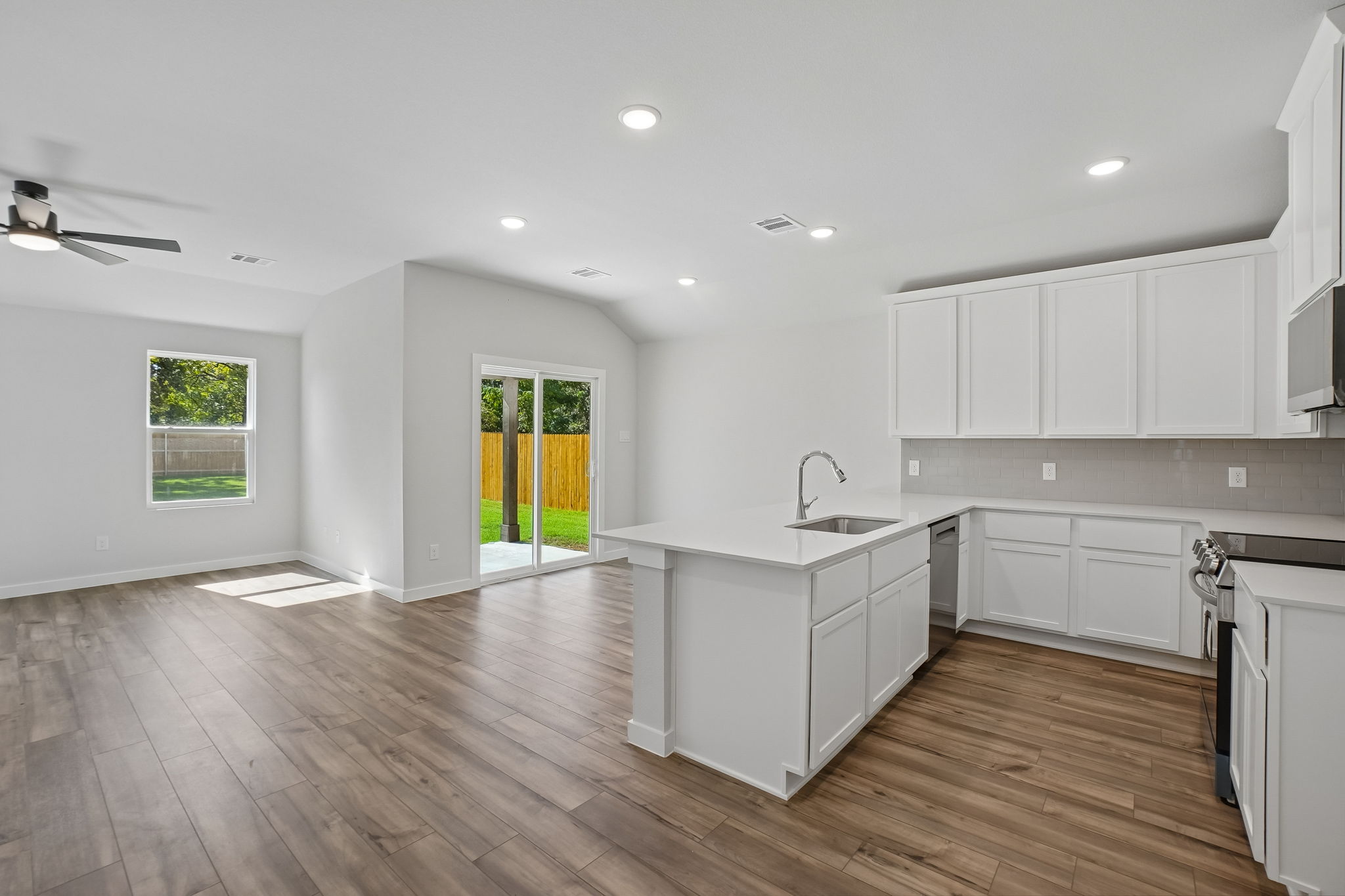 A kitchen with white cabinets.