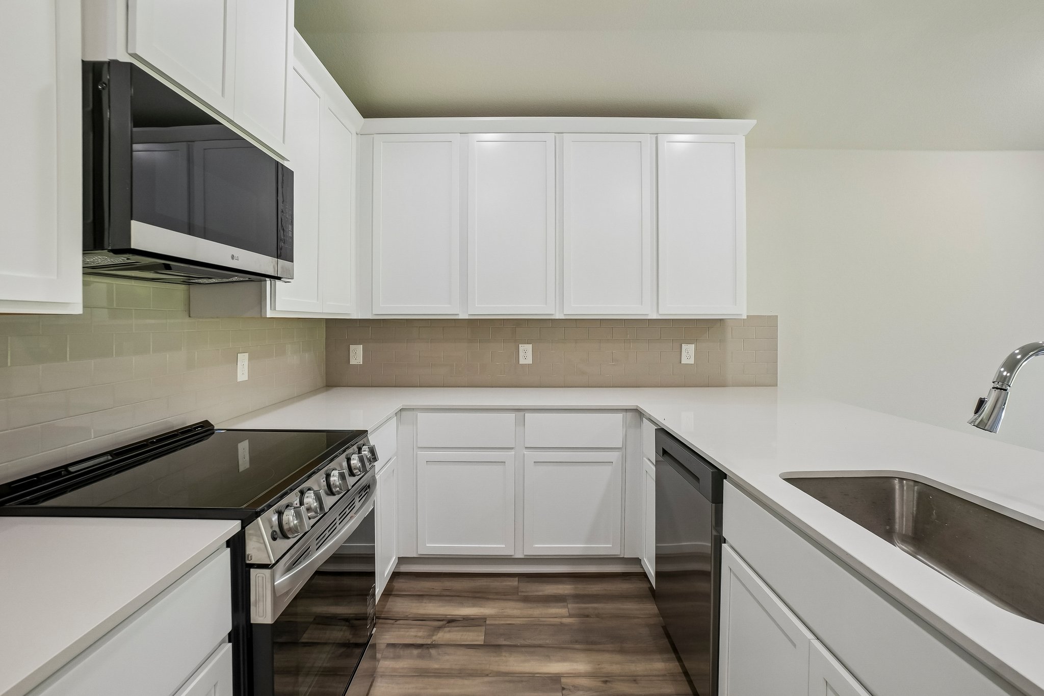 A kitchen with white cabinets.