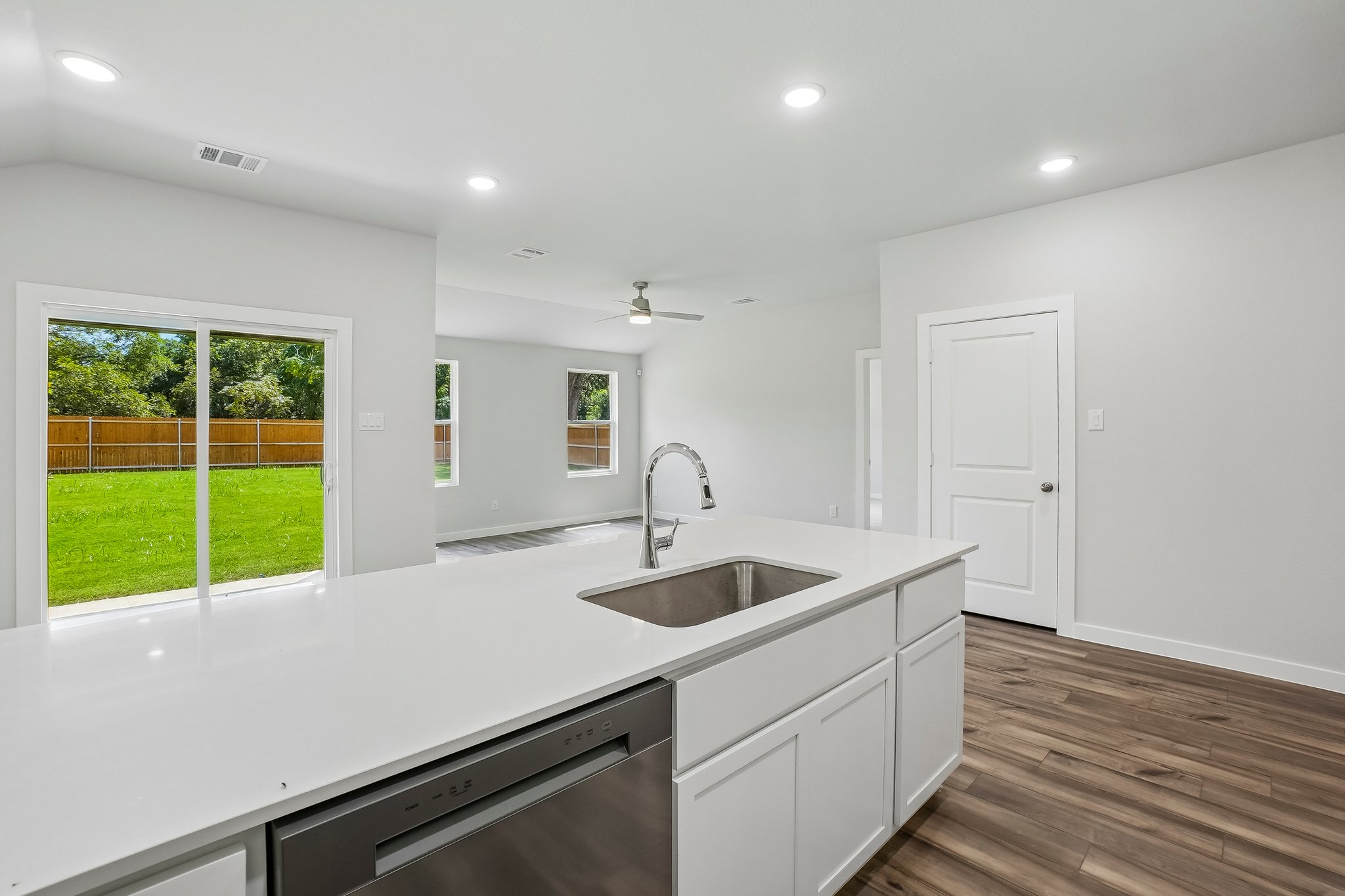 A kitchen with white cabinets.
