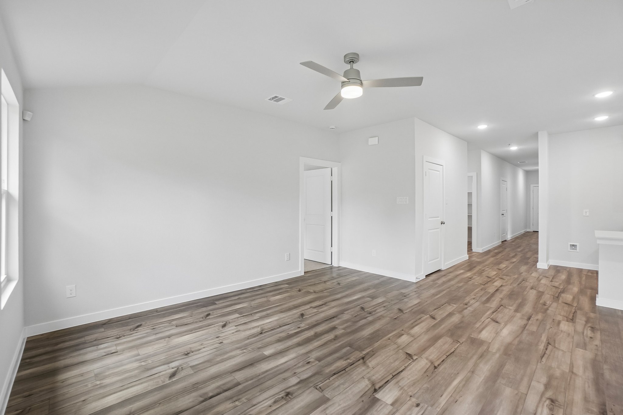 A room with white walls and a wood floor.