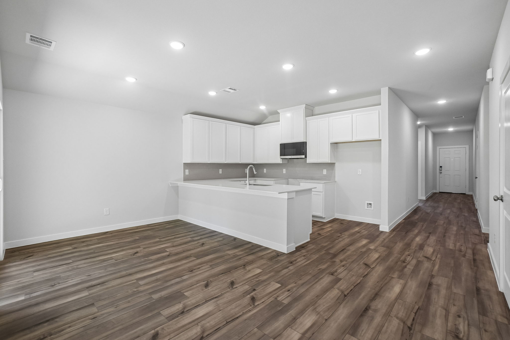 A kitchen with white cabinets.