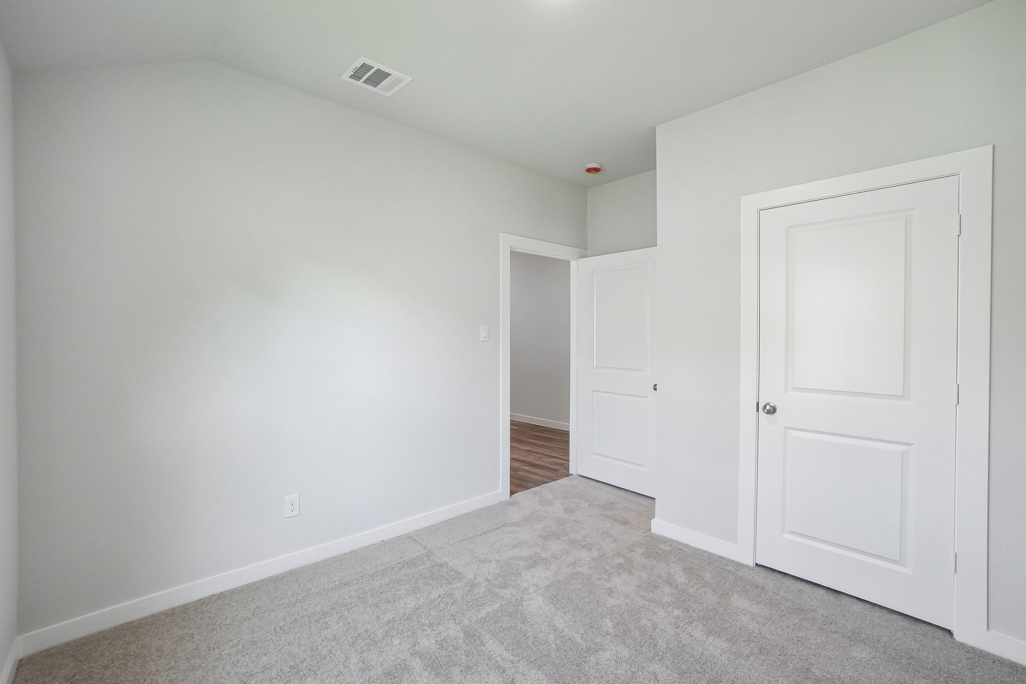 A hallway with white doors.