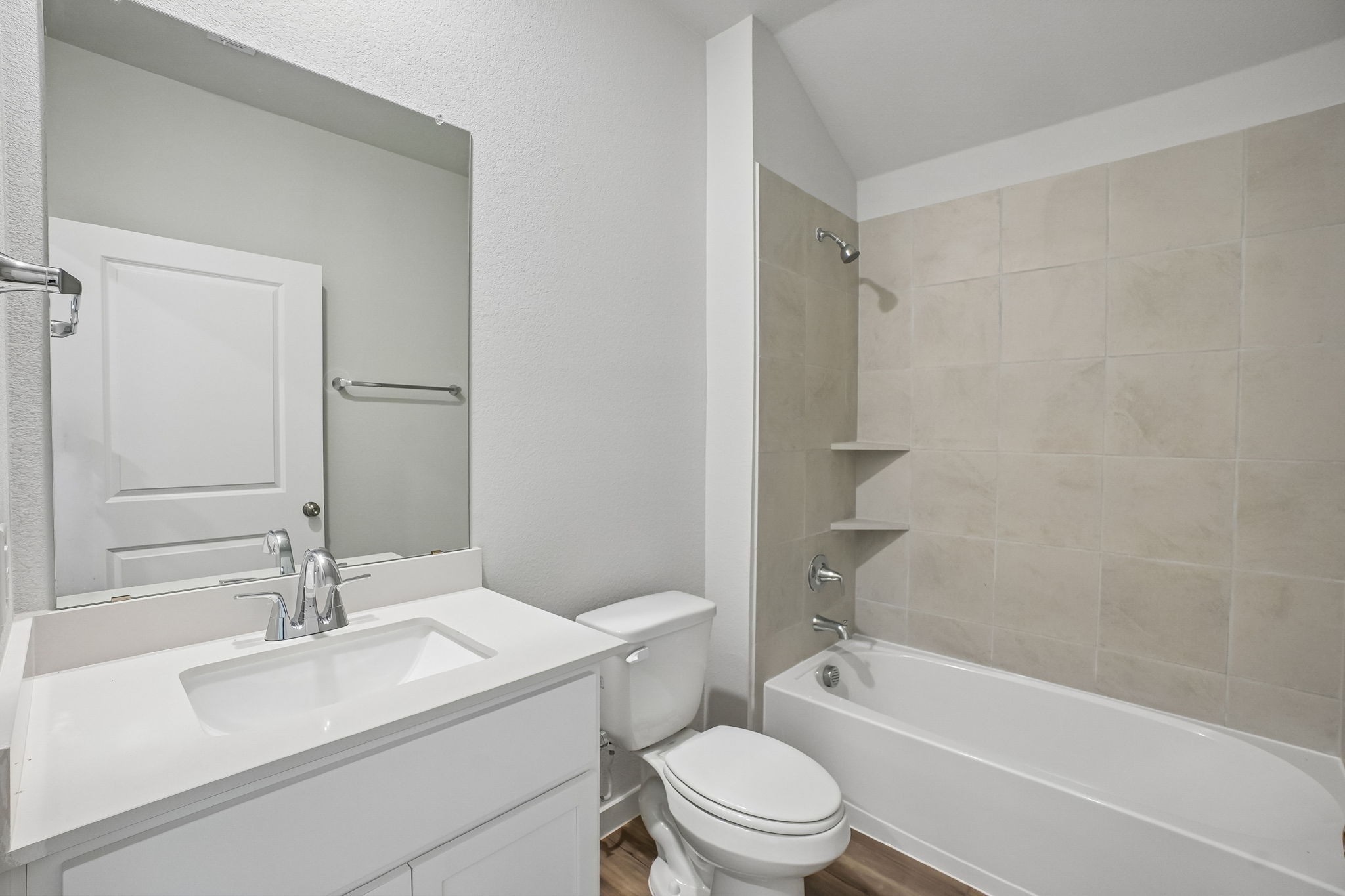 A bathroom with a tub toilet and sink.
