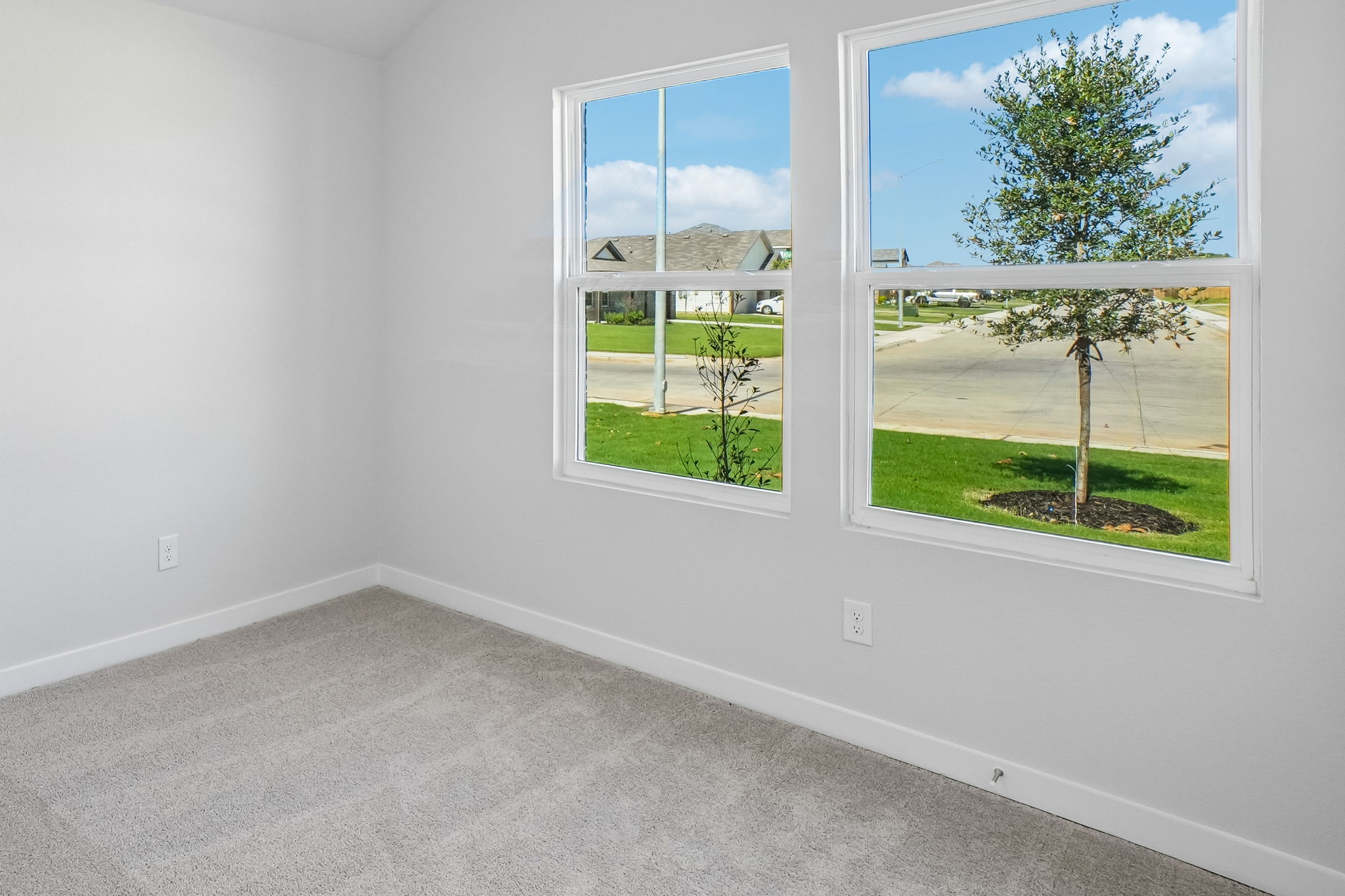 A room with a window and trees.