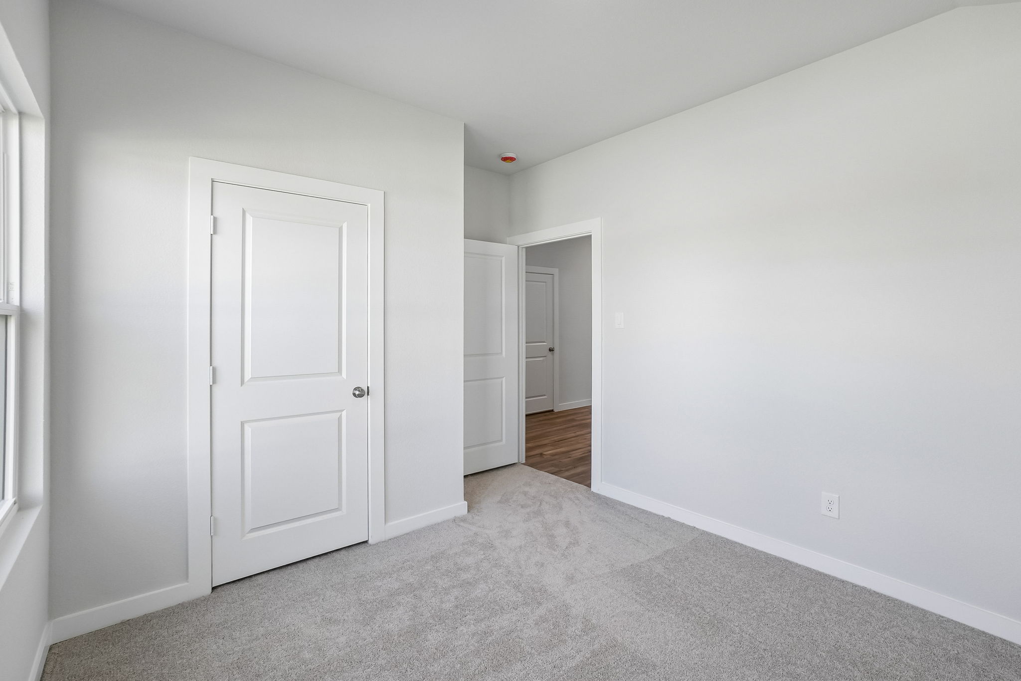 A hallway with white doors.