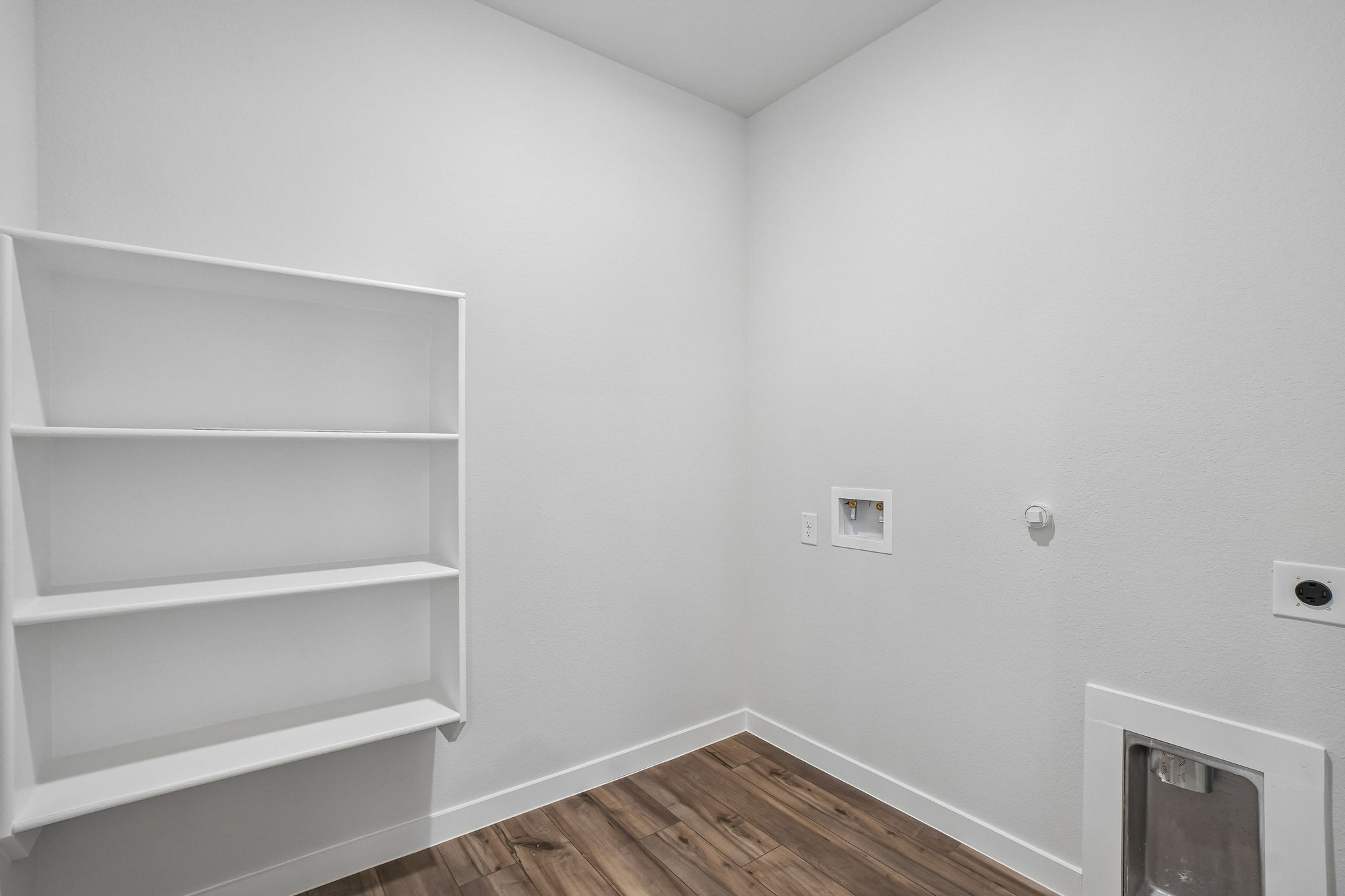 A white room with a white shelf.