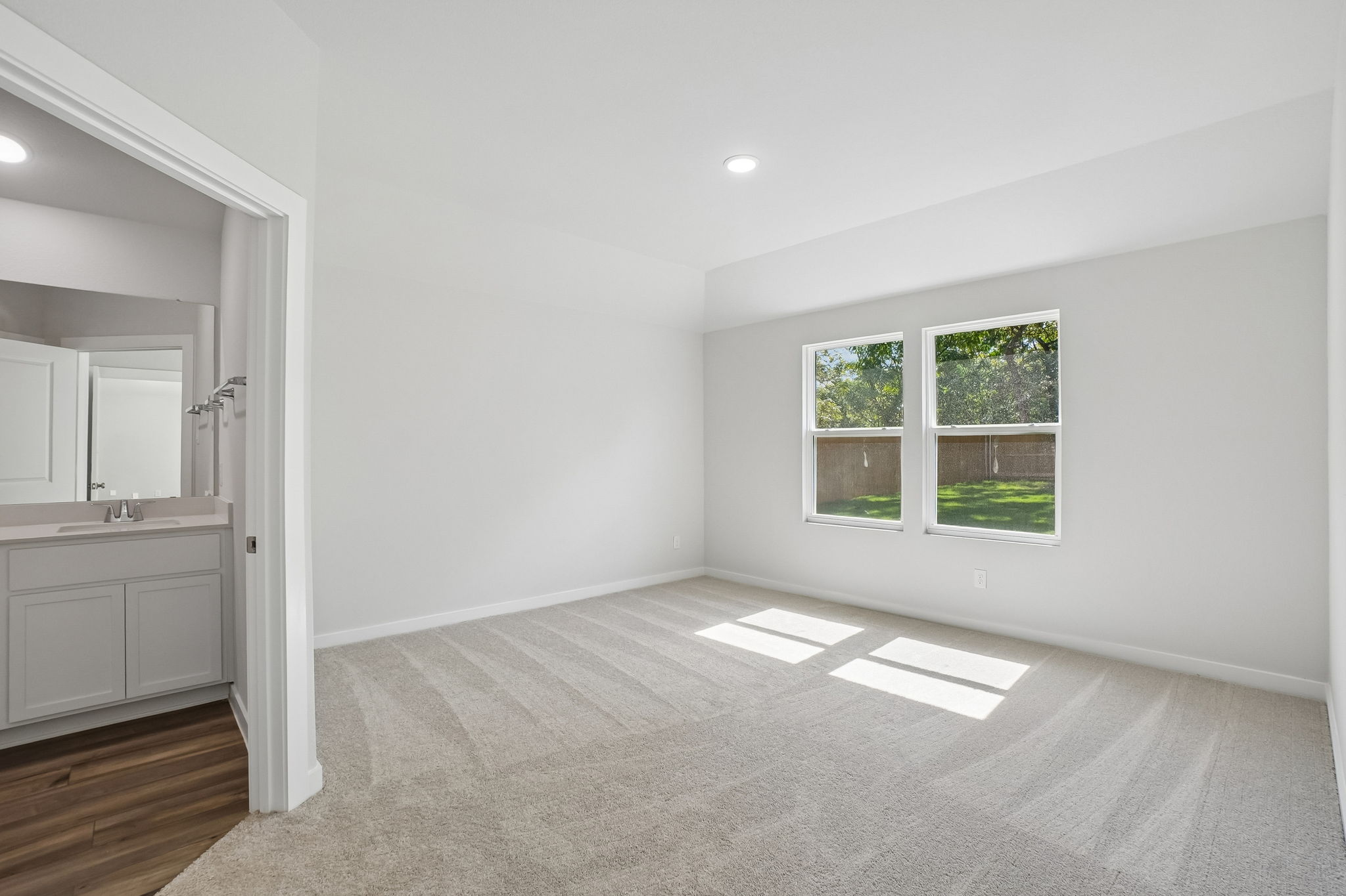 A room with a white wall and a window.