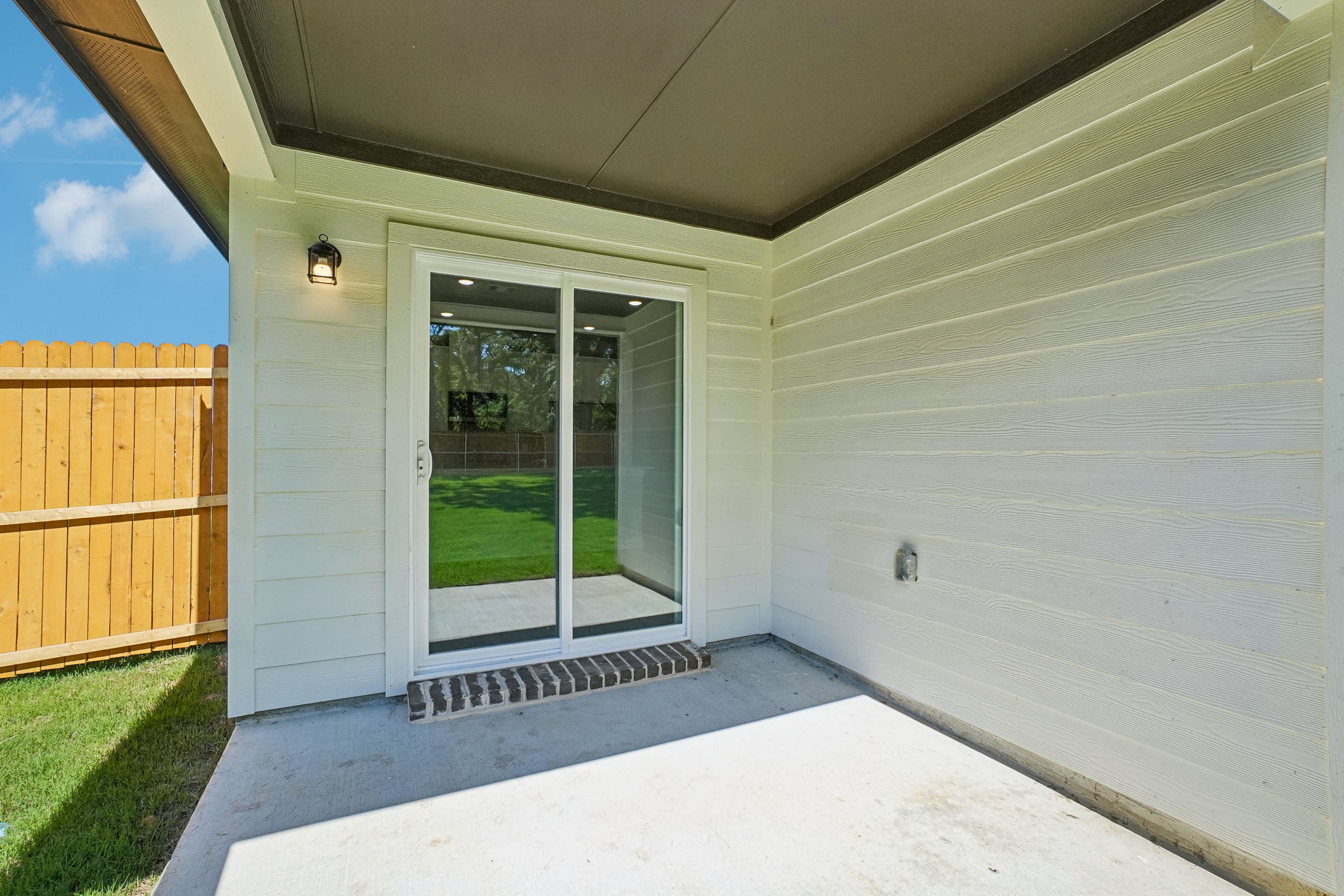 A white building with a glass door.