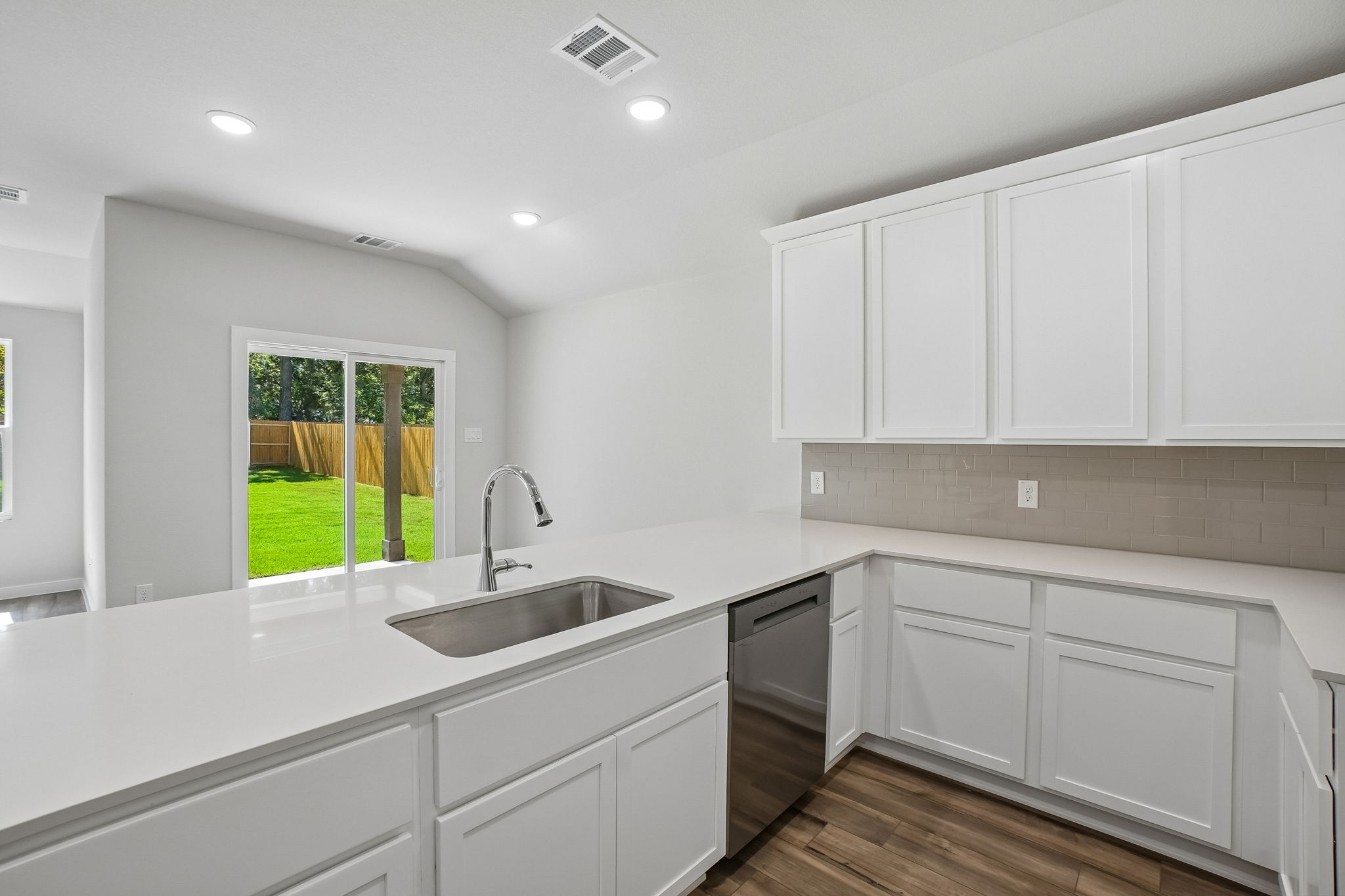 A kitchen with white cabinets.
