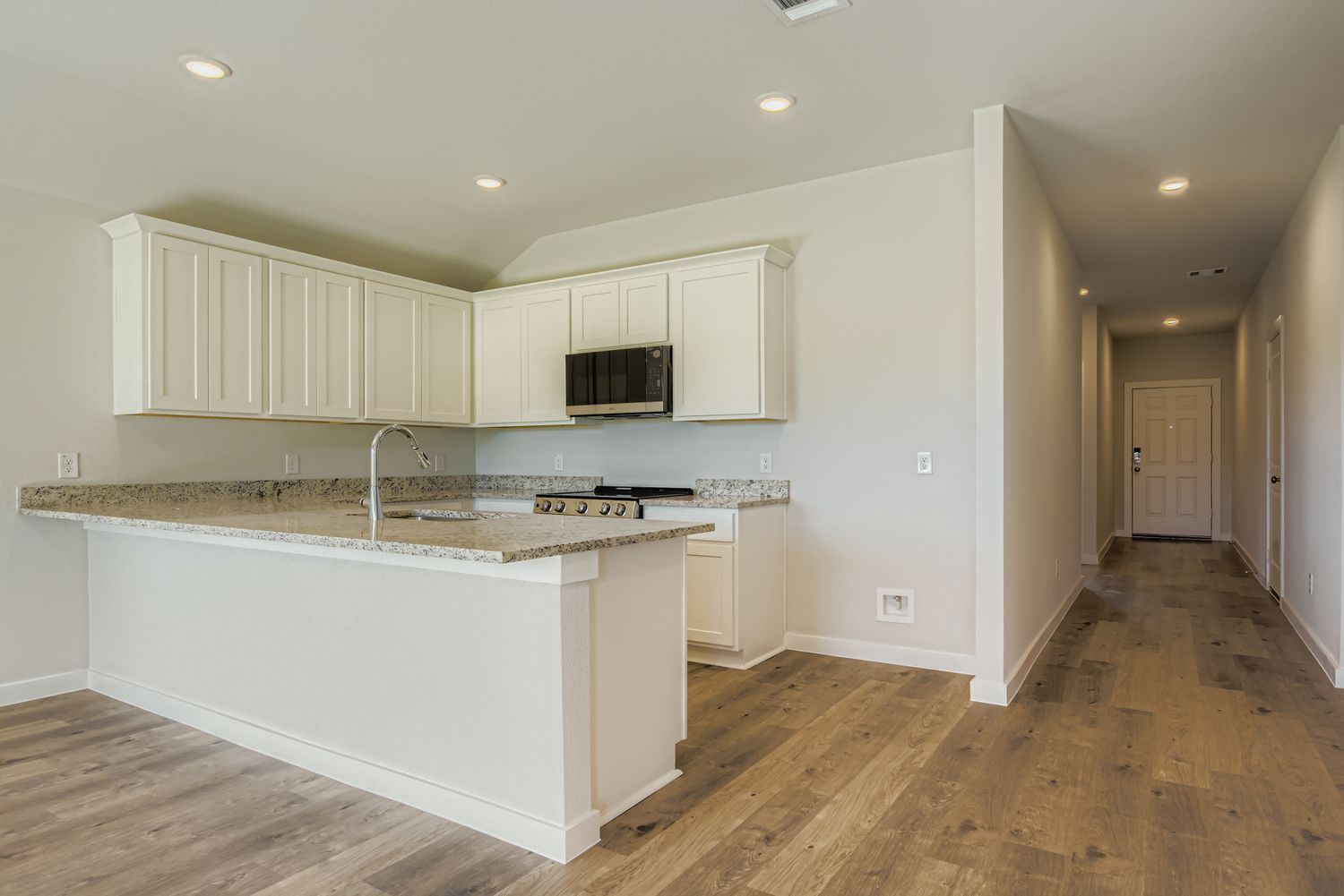 A kitchen with white cabinets.