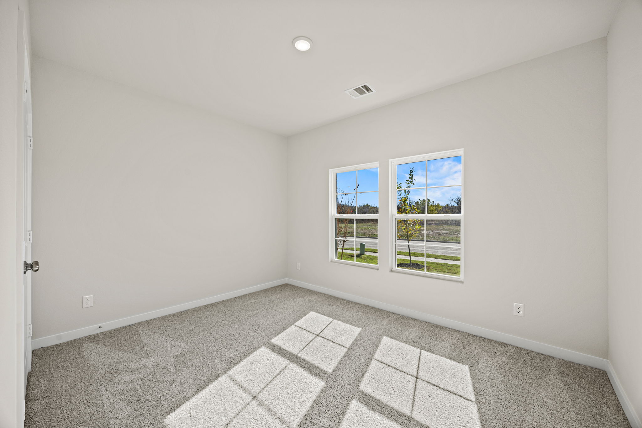 A room with a tile floor and windows.